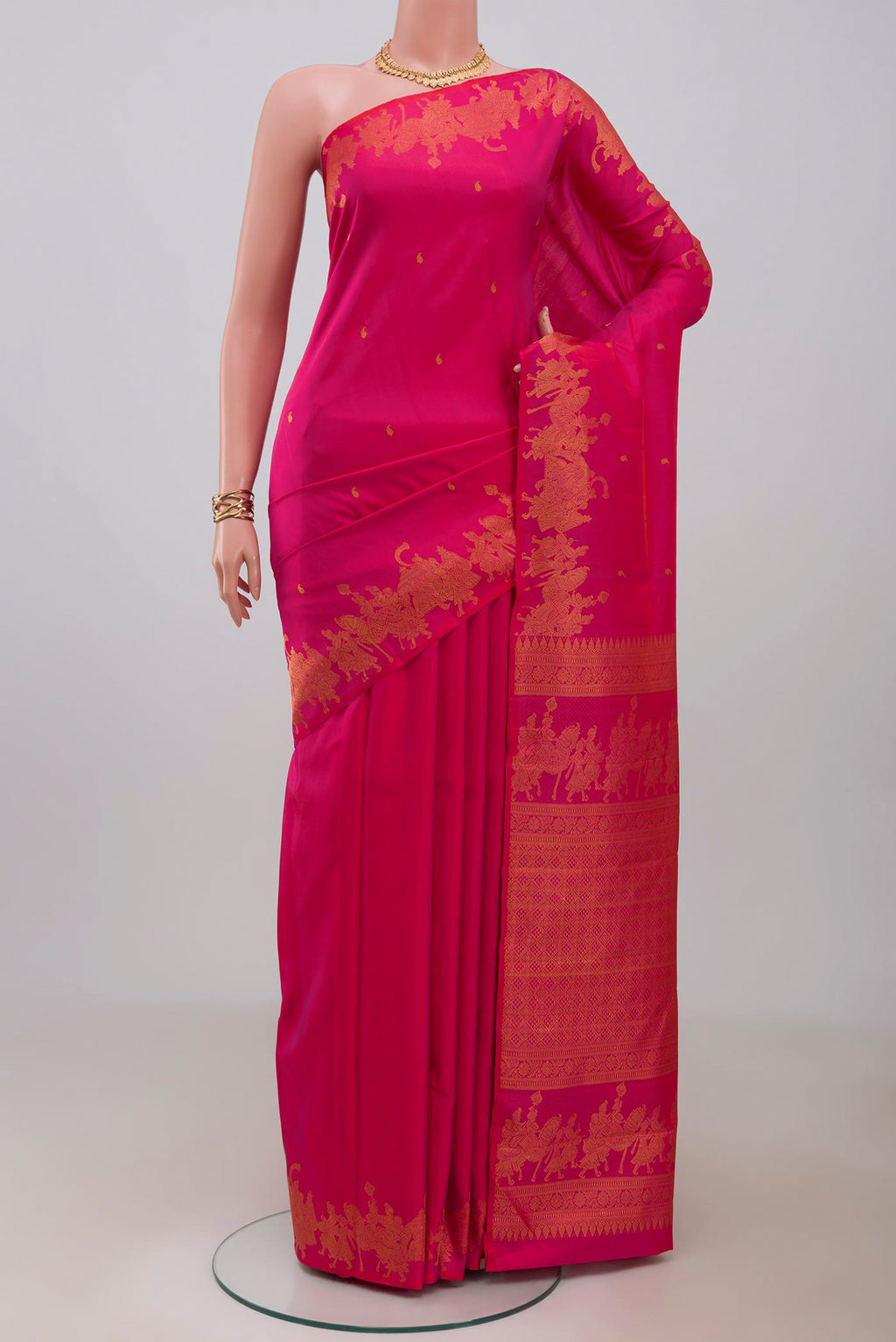 Pink Kanjivaram Silk Saree with Zari Butta on the body and Fancy Border.  displayed on a mannequin