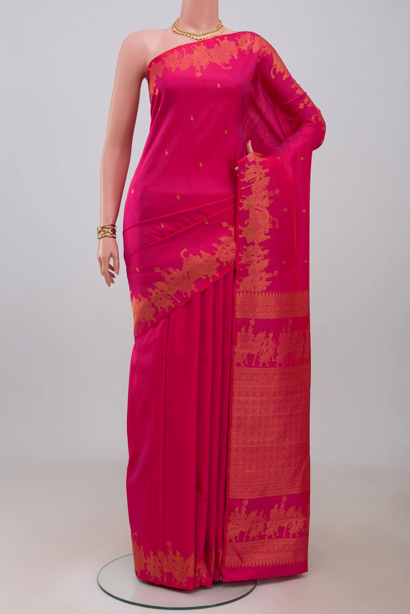 Pink Kanjivaram Silk Saree with Zari Butta on the body and Fancy Border.  displayed on a mannequin