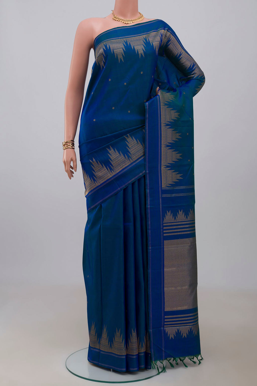 Pure Silk Pure Zari Blue Kanchipuram Saree with Zari Butta on the body and Temple Border.  displayed on a mannequin