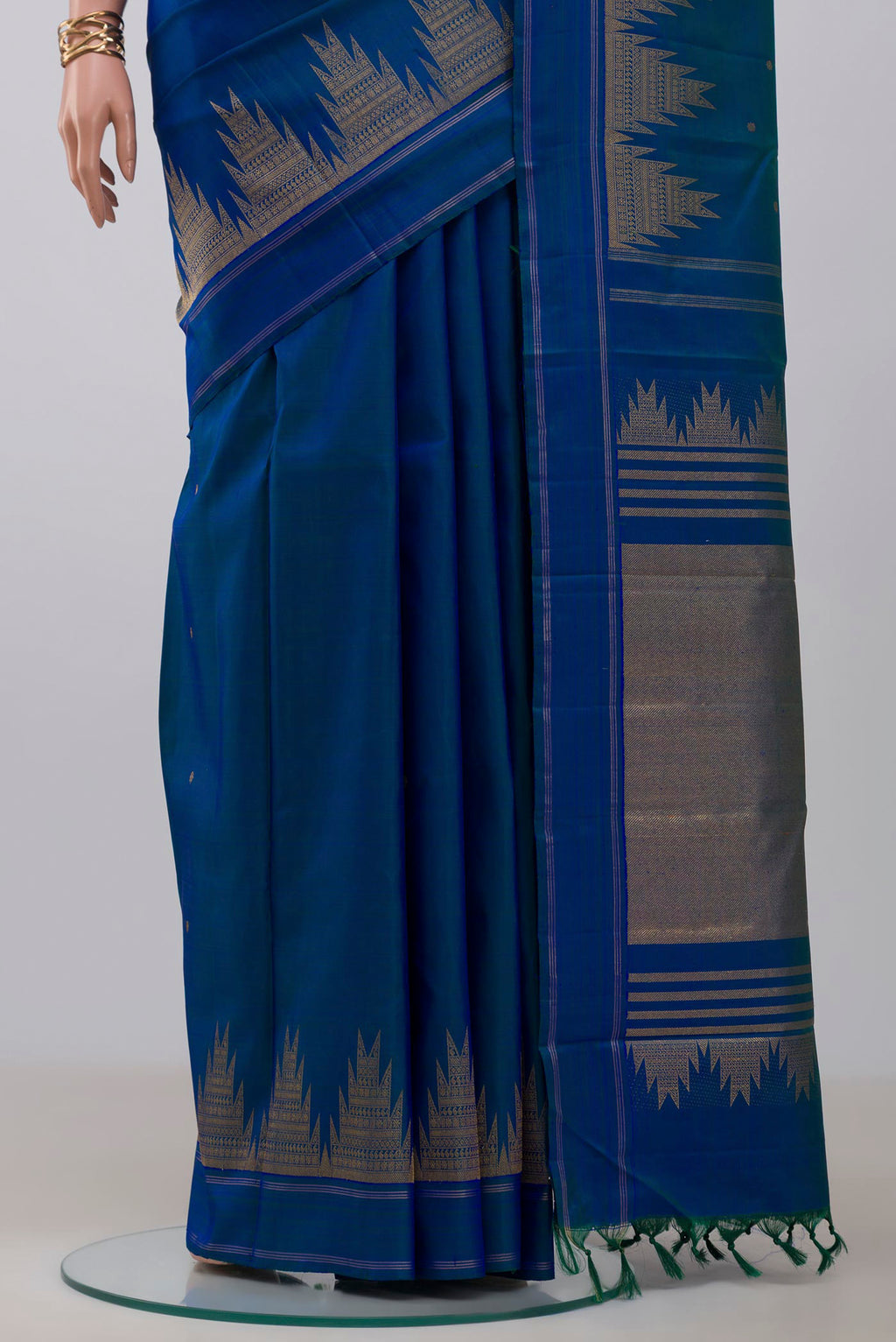 Pleats and pallu of Pure Silk Pure Zari Blue Kanchipuram Saree with Zari Butta on the body and Temple Border. 