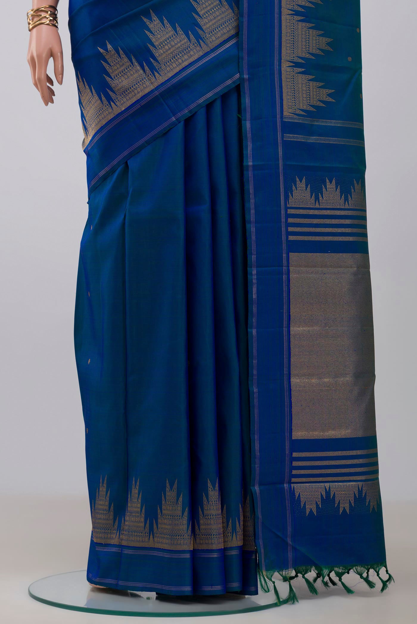 Pleats and pallu of Pure Silk Pure Zari Blue Kanchipuram Saree with Zari Butta on the body and Temple Border. 