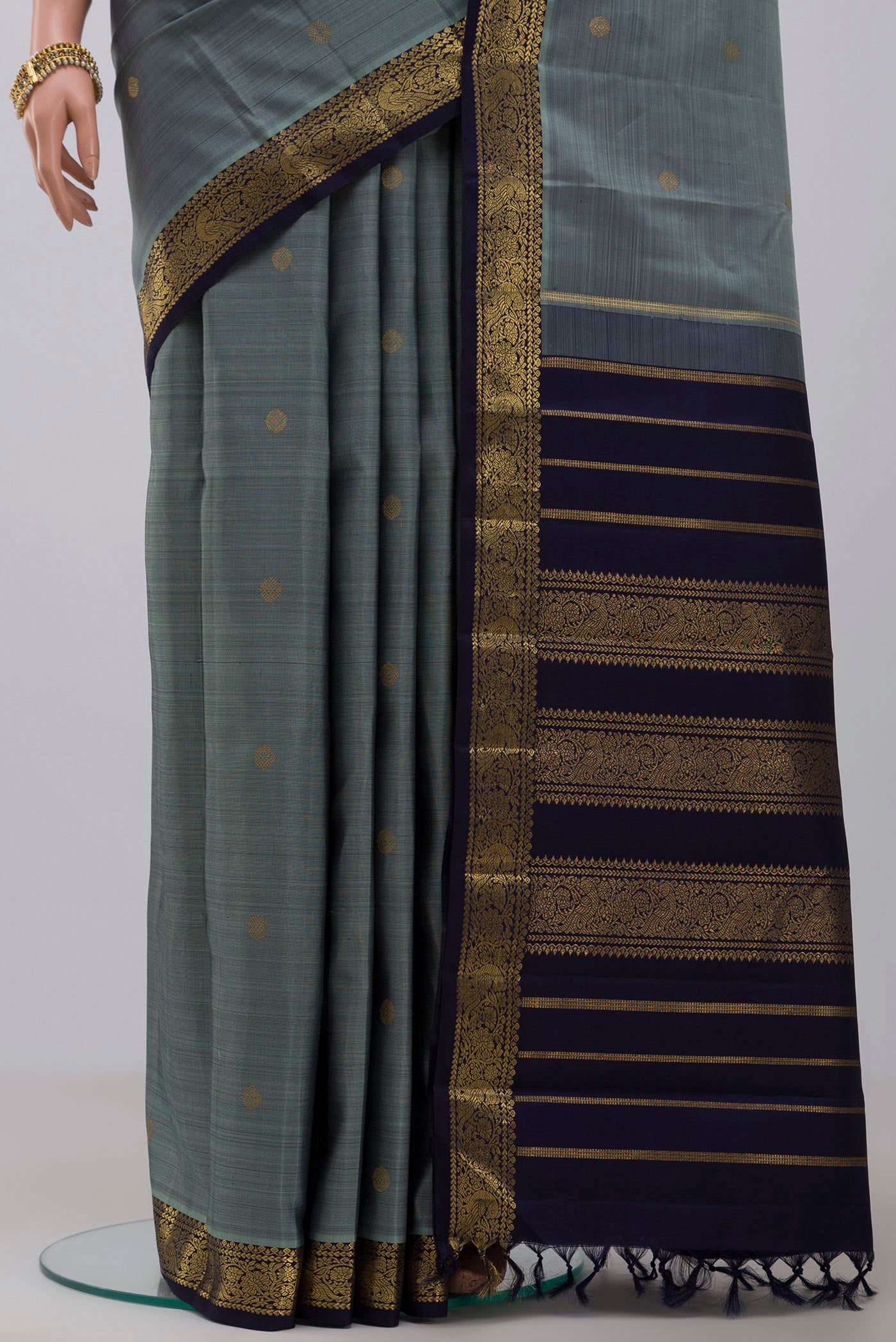 Pleats and pallu of Pure Silk Pure Zari Grey Kanchipuram Saree with Zari Butta on the body and Zari Border. 