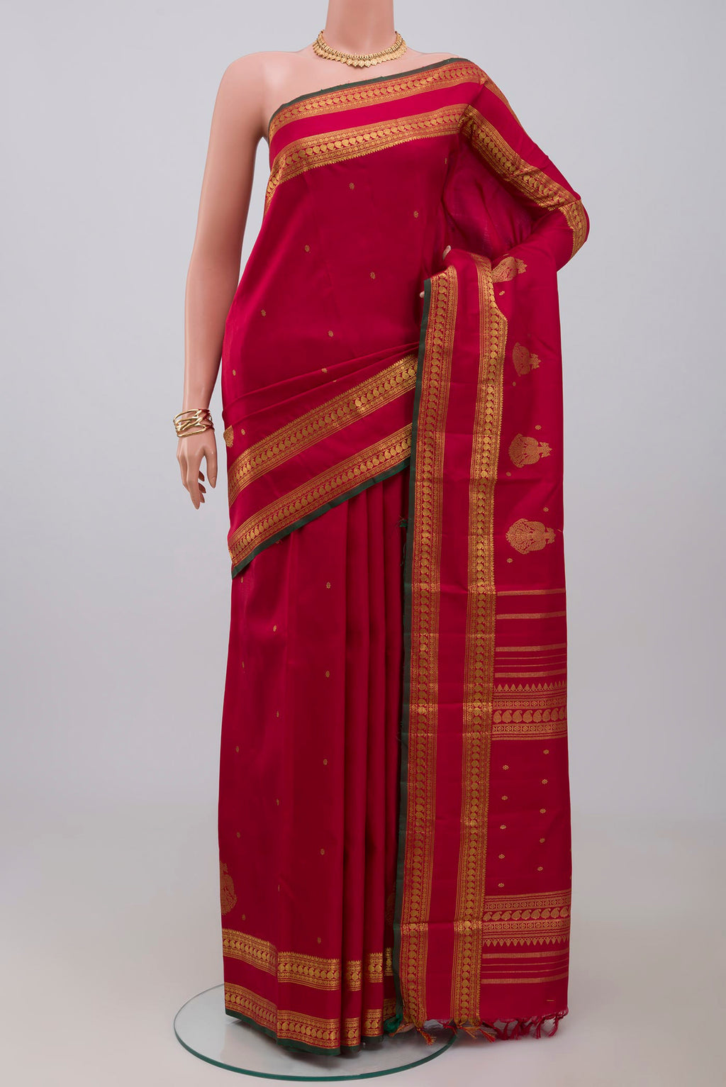 Pure Silk Pure Zari Maroon Kanchipuram Saree with Zari Butta on the body and Zari Border.  displayed on a mannequin
