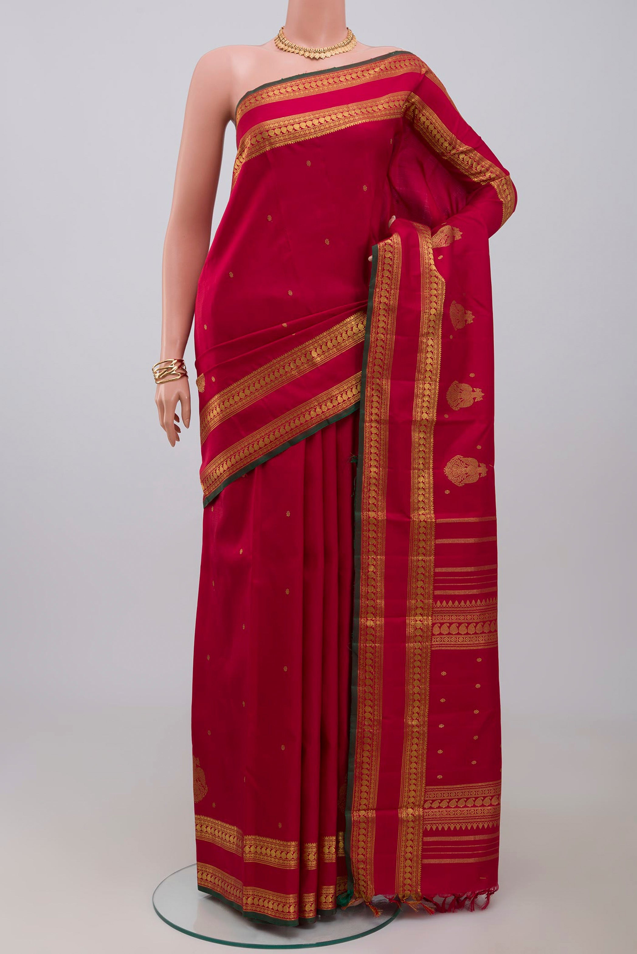 Pure Silk Pure Zari Maroon Kanchipuram Saree with Zari Butta on the body and Zari Border.  displayed on a mannequin