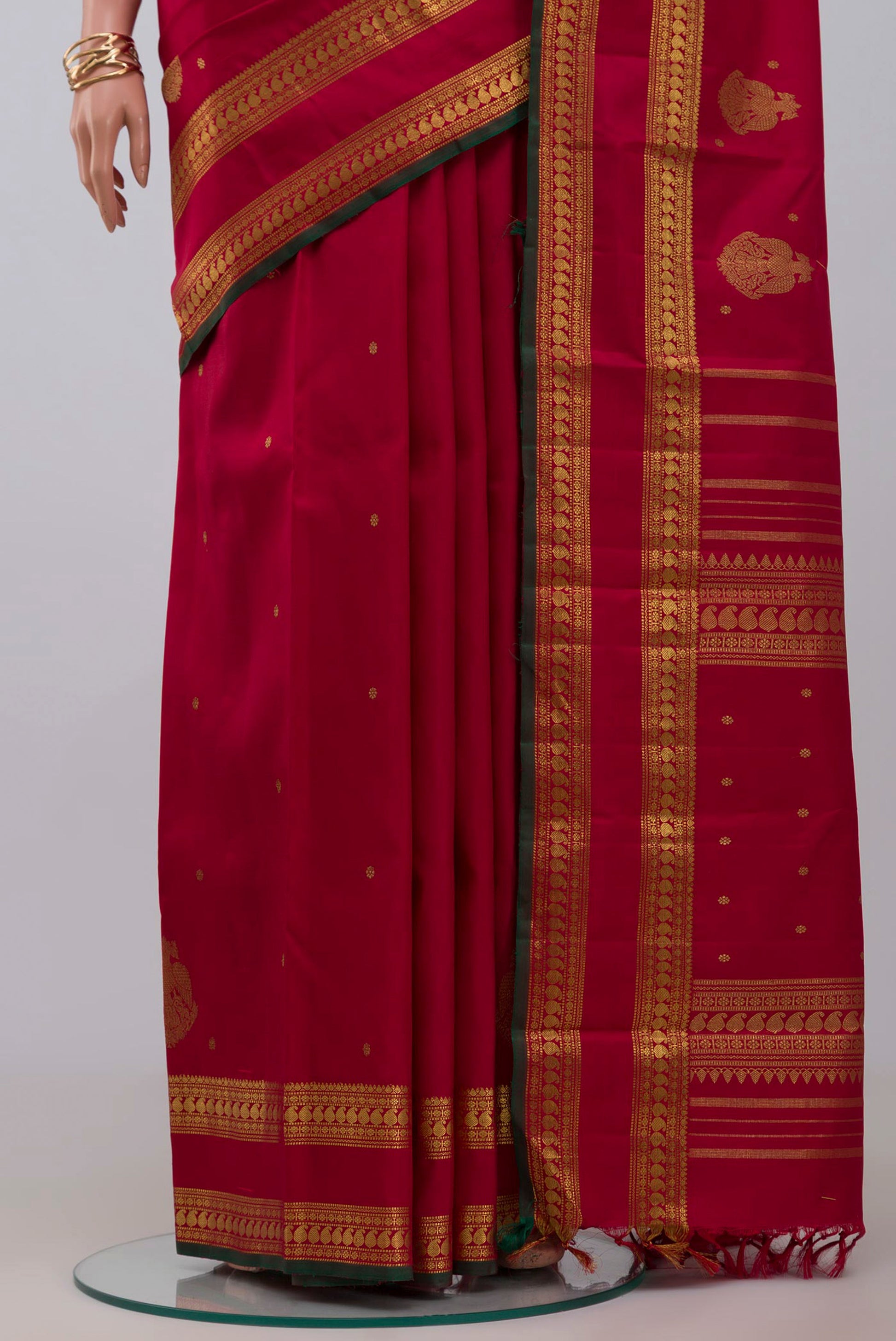Pleats and pallu of Pure Silk Pure Zari Maroon Kanchipuram Saree with Zari Butta on the body and Zari Border. 