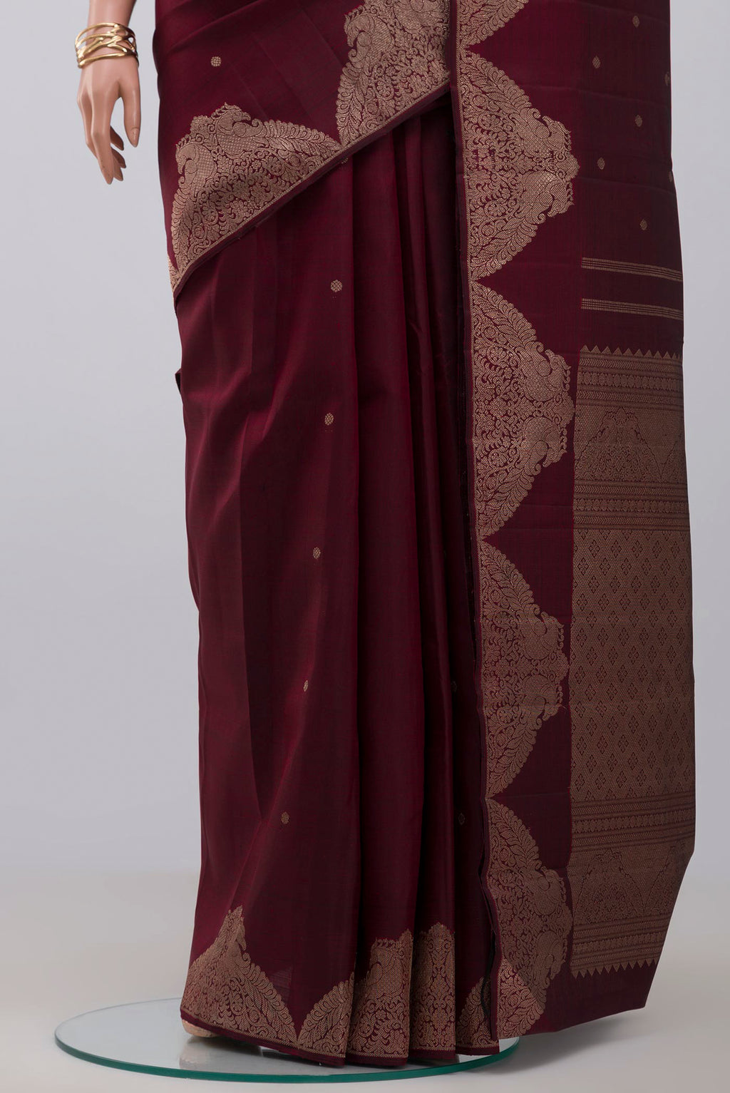 Pleats and pallu of Pure Silk Pure Zari Maroon Kanjivaram Saree with Zari Butta on the body and Fancy Border. 