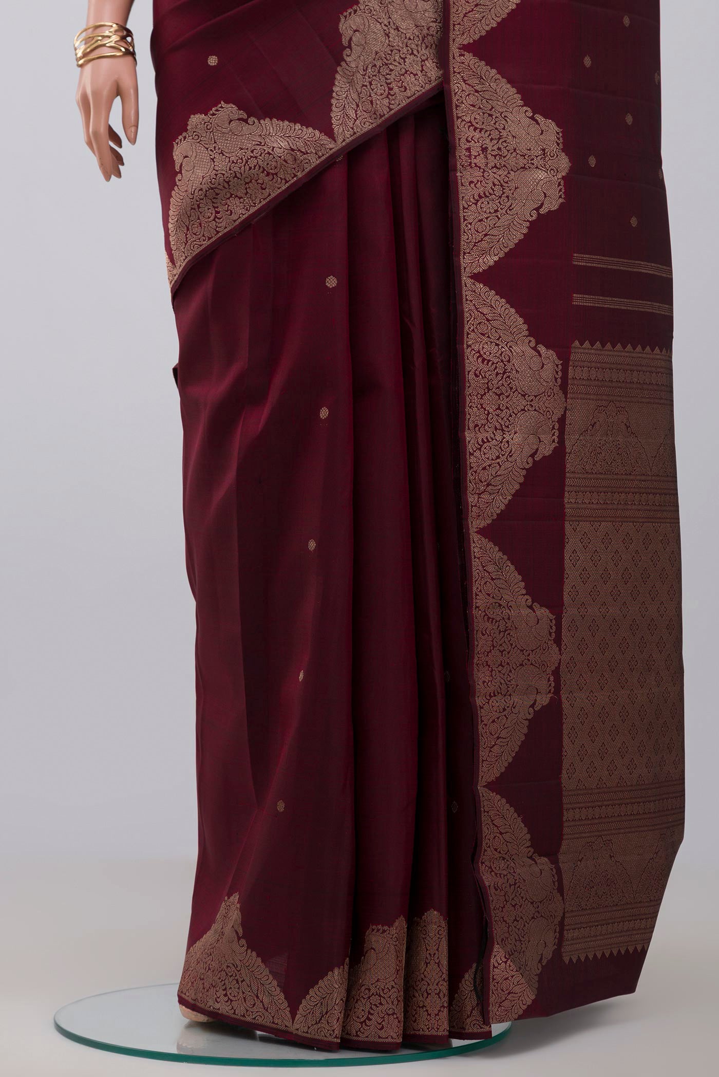 Pleats and pallu of Pure Silk Pure Zari Maroon Kanjivaram Saree with Zari Butta on the body and Fancy Border. 