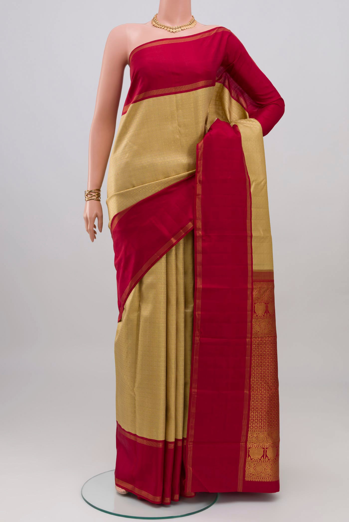 Golden Kanchipuram Silk Saree with Zari Brocade on the body and Thin Zari Line.  displayed on a mannequin