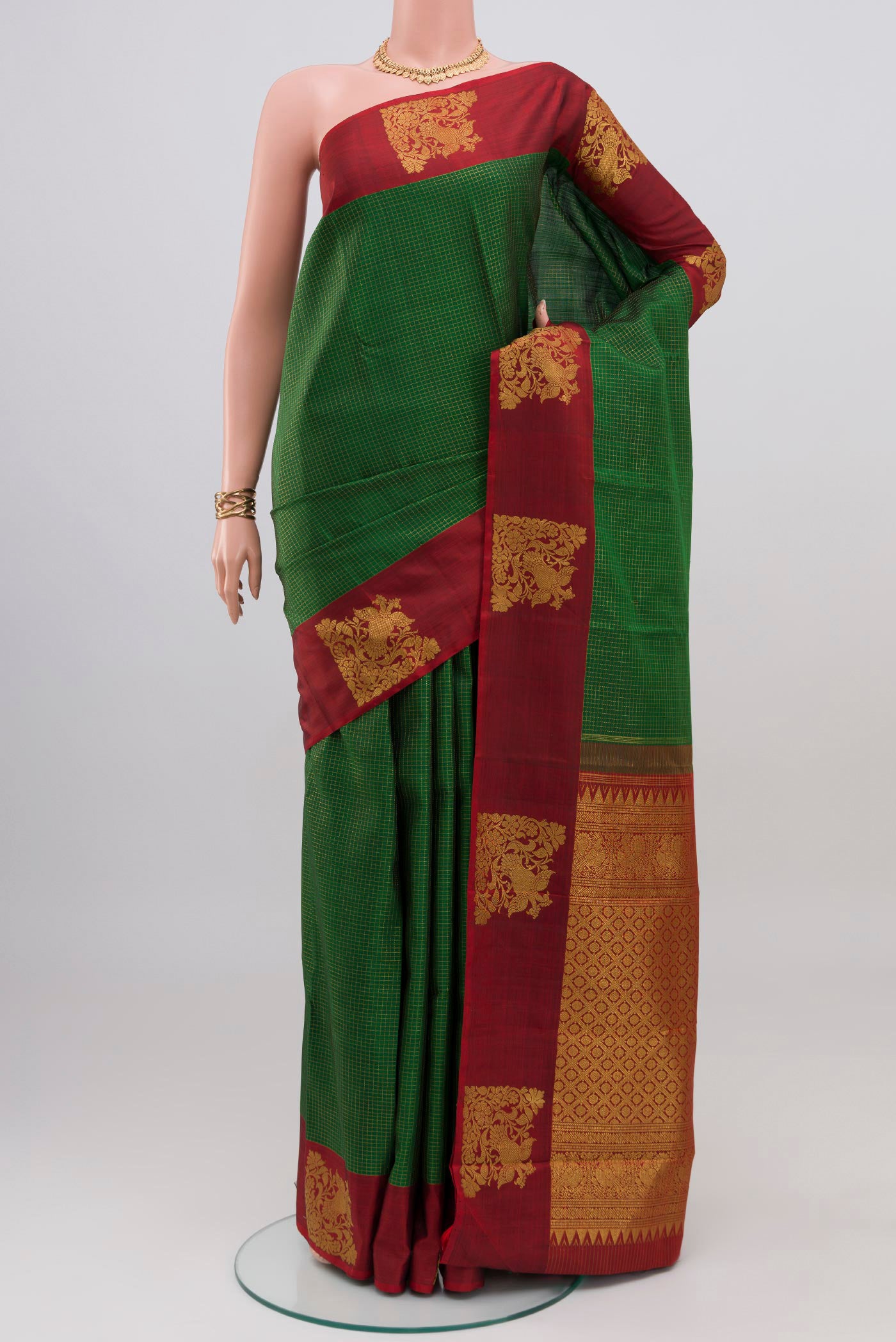 Green Kanjivaram Silk Saree with Checked design on the body and Fancy Border.  displayed on a mannequin