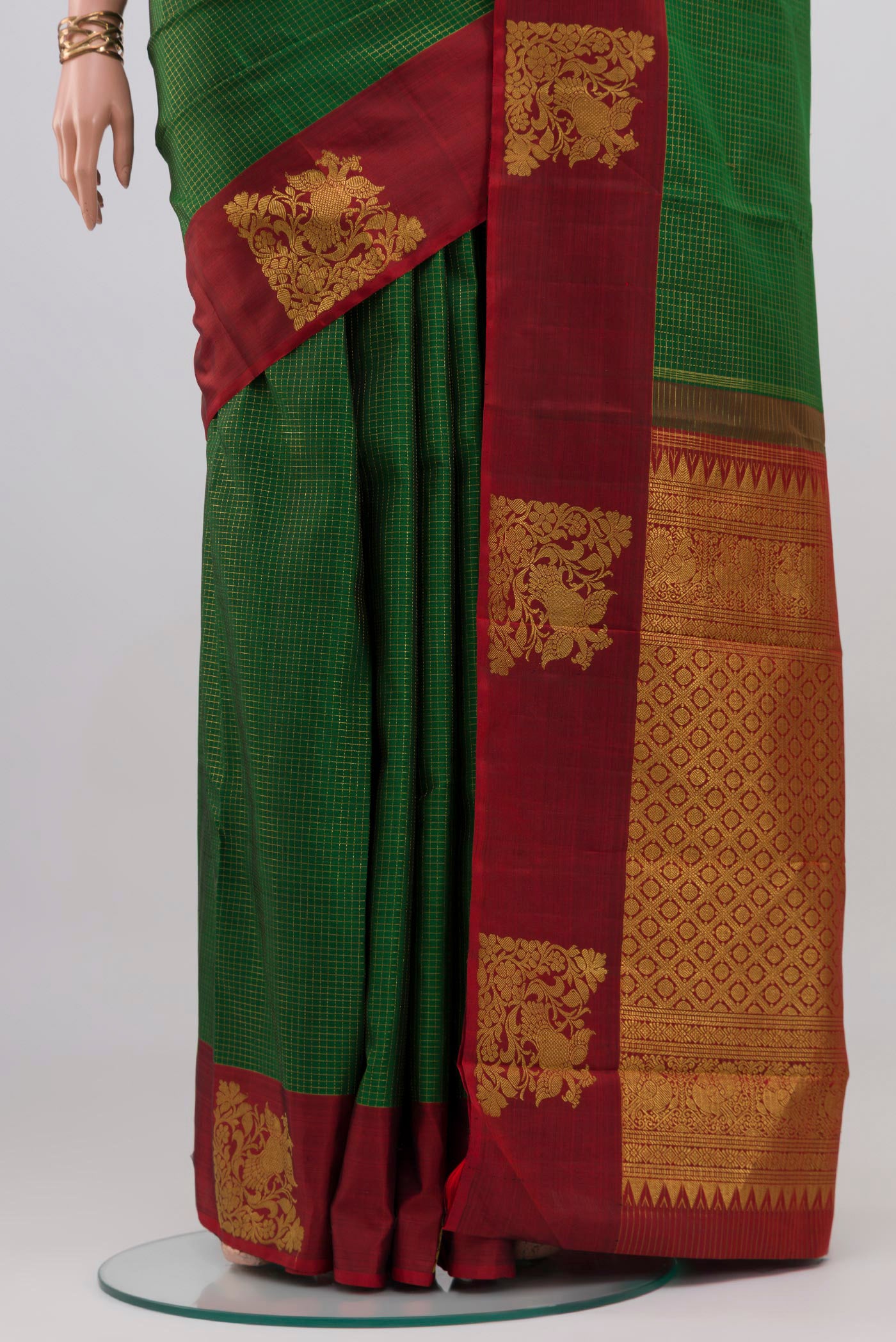 Pleats and pallu of Green Kanjivaram Silk Saree with Checked design on the body and Fancy Border. 