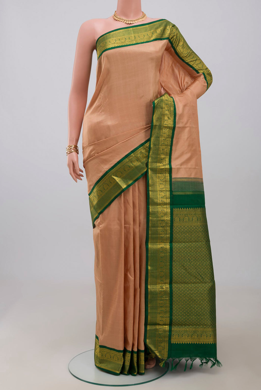 Pure Silk Pure Zari Beige Kanjivaram Saree with Plain Body and Zari Border.  displayed on a mannequin