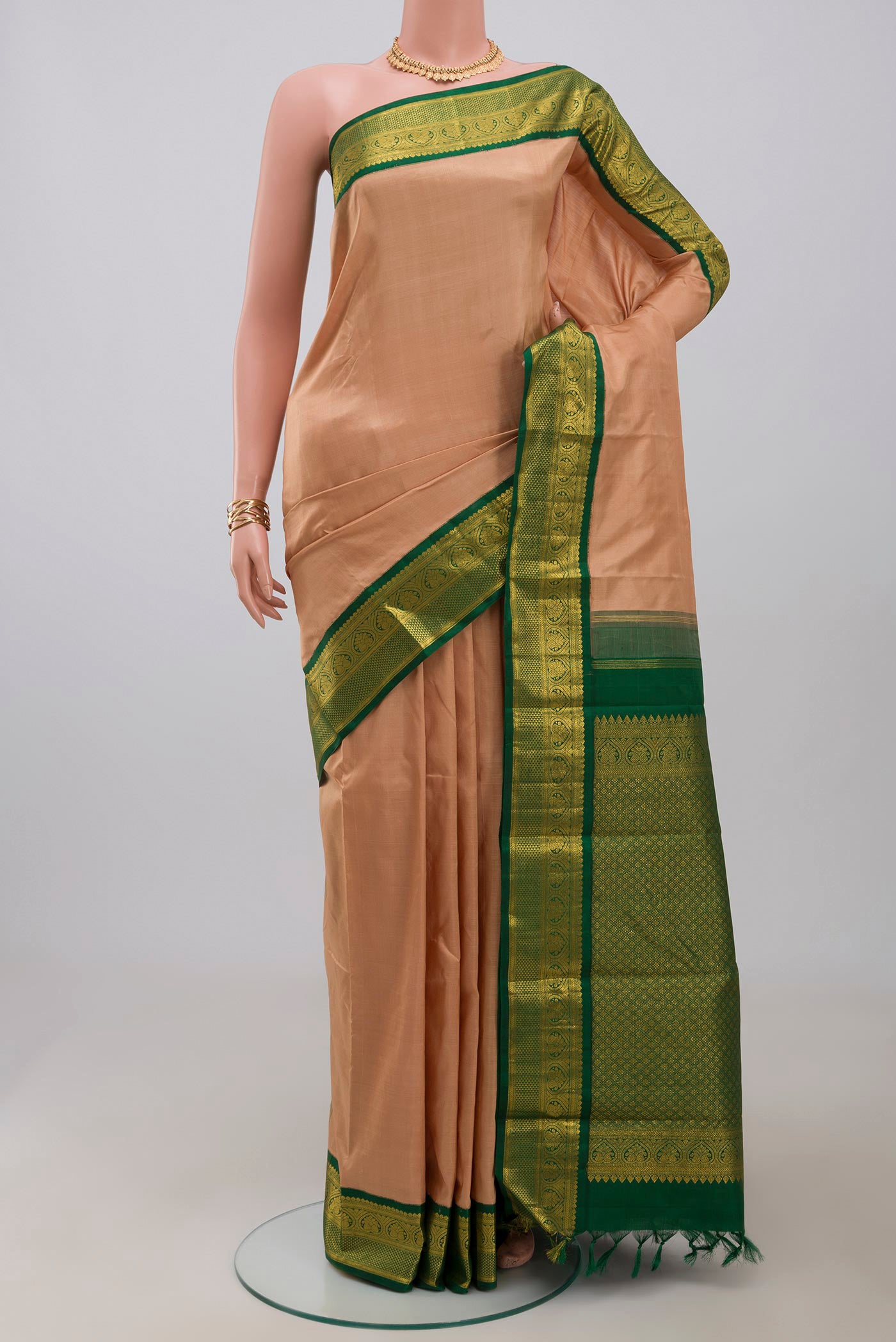 Pure Silk Pure Zari Beige Kanjivaram Saree with Plain Body and Zari Border.  displayed on a mannequin