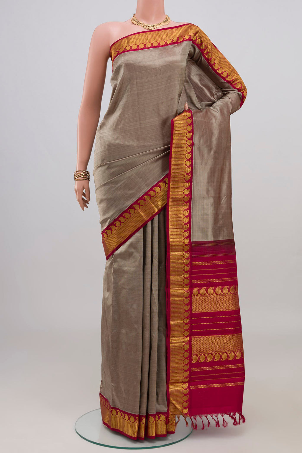 Grey Kanjivaram Silk Saree with Plain Body and Zari Border.  displayed on a mannequin