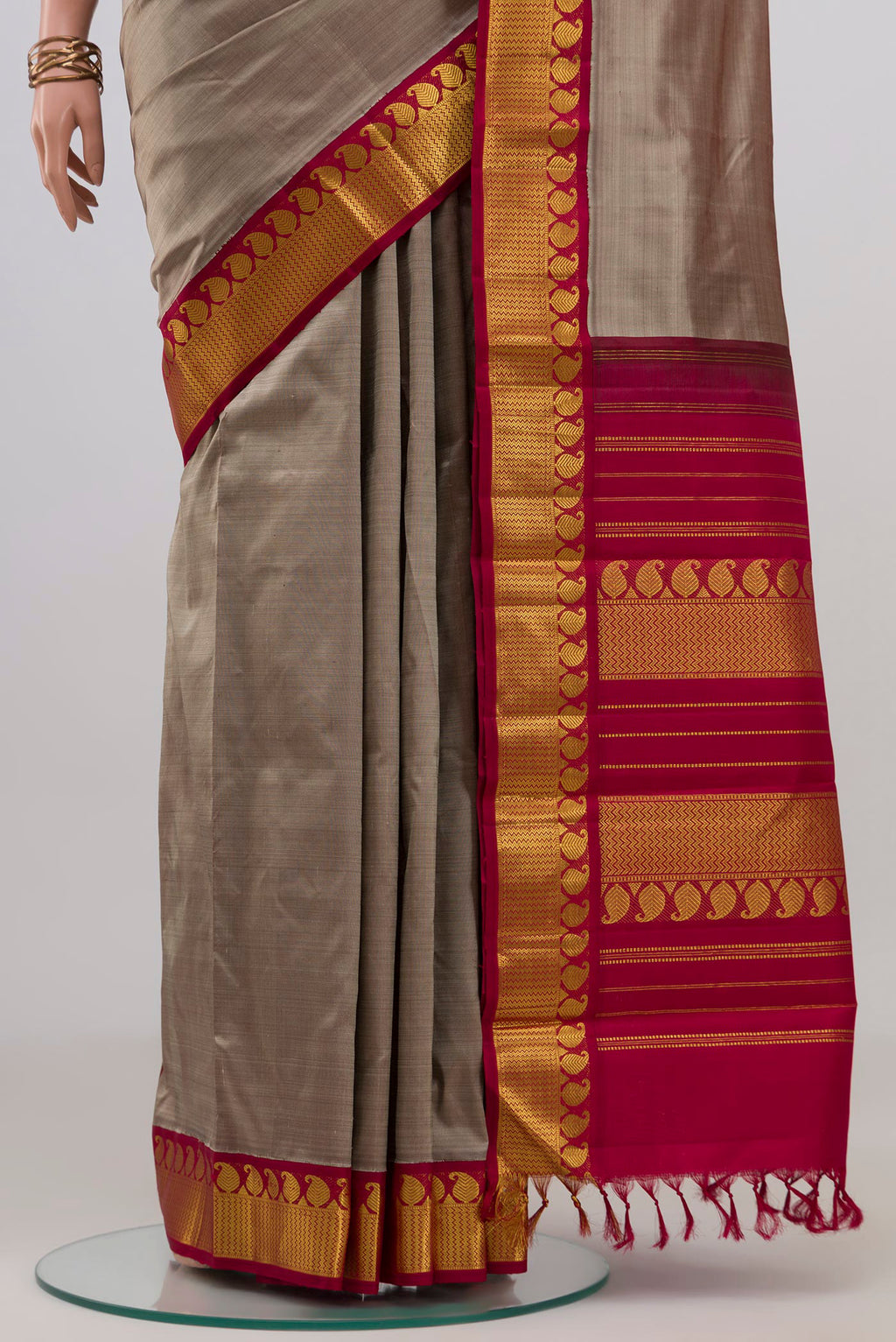 Pleats and pallu of Grey Kanjivaram Silk Saree with Plain Body and Zari Border. 