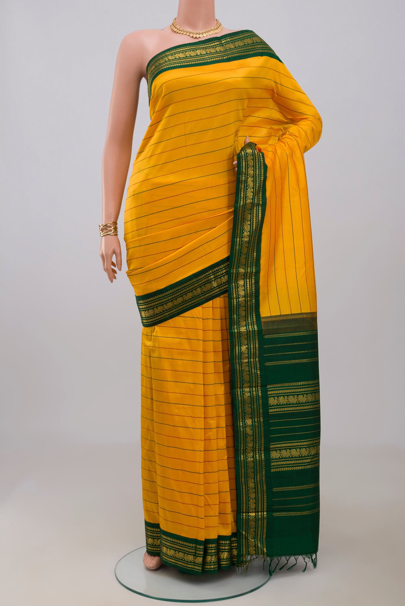 Pure Silk Pure Zari Yellow Kanjivaram Saree with Veldhari on the body and Zari Border.  displayed on a mannequin