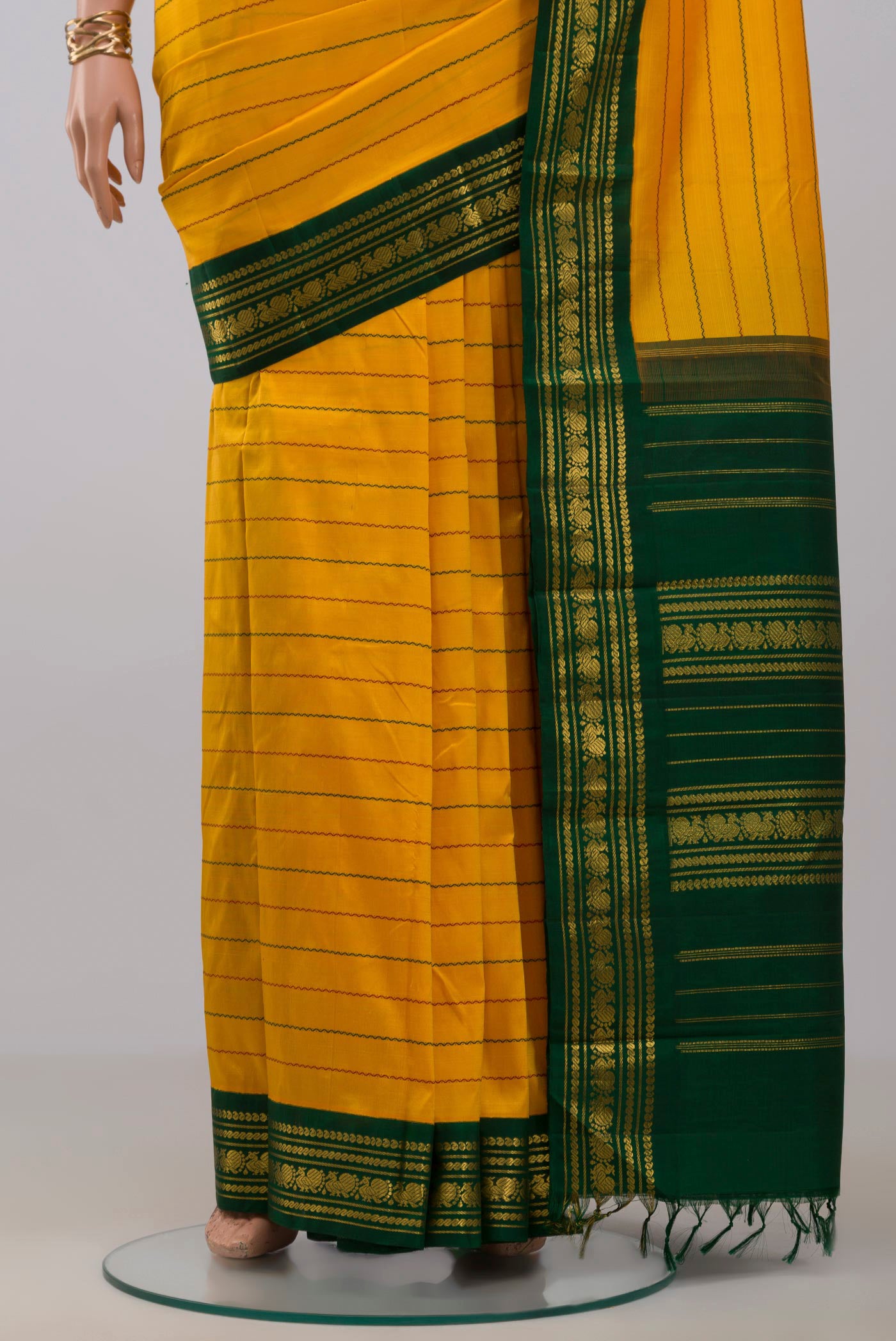 Pleats and pallu of Pure Silk Pure Zari Yellow Kanjivaram Saree with Veldhari on the body and Zari Border. 