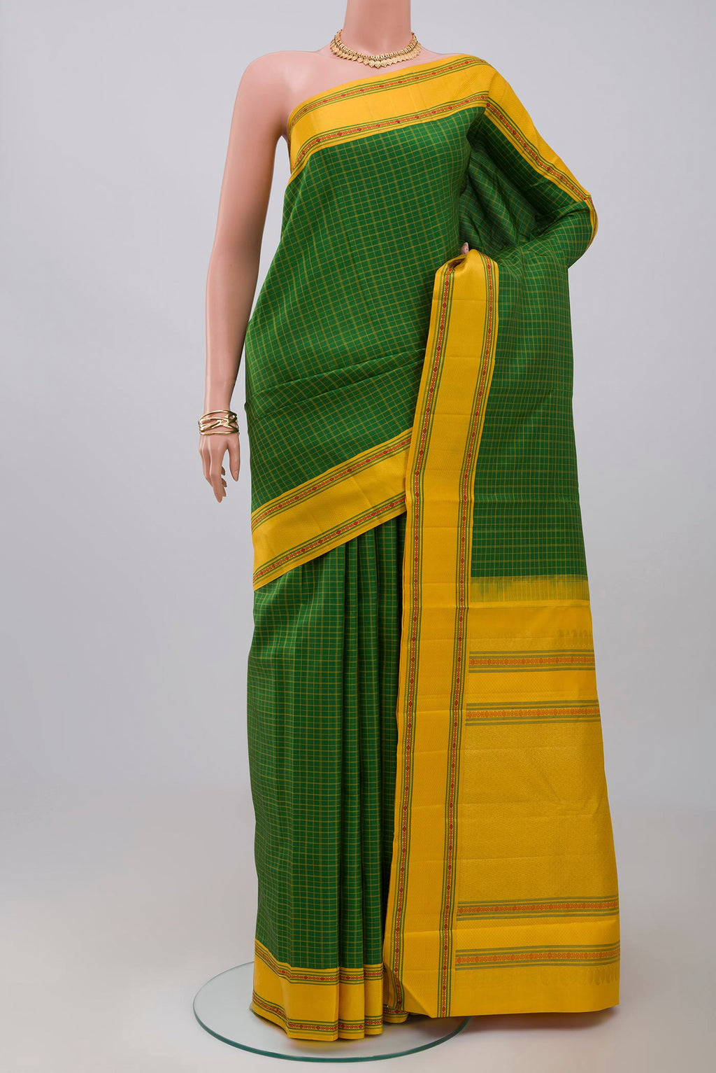 Green Kanjivaram Saree with Checked design on the body and Thread Border.  displayed on a mannequin