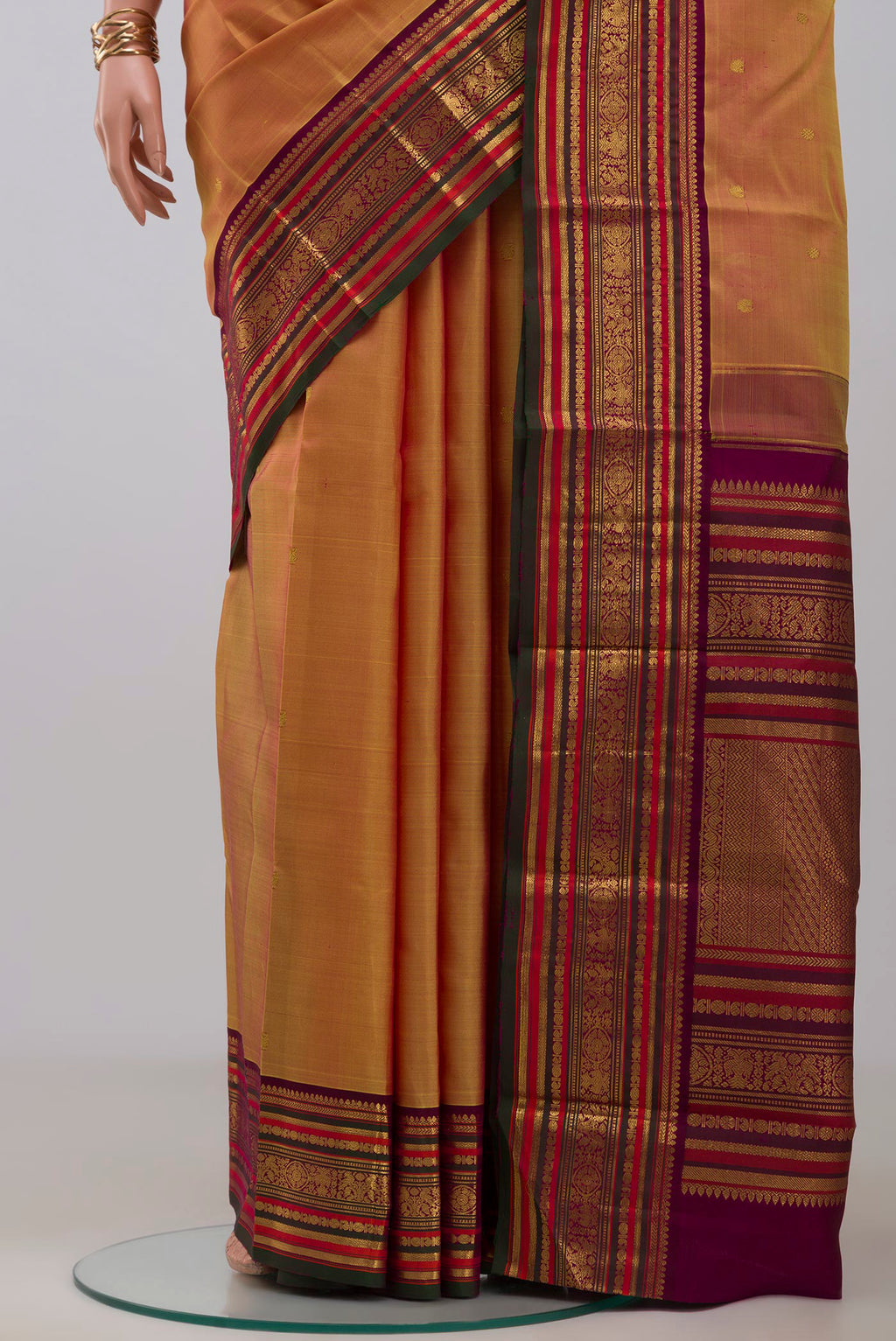 Pleats and pallu of Mustard Kanjivaram Silk Saree with Zari Butta on the body and Zari Border. 