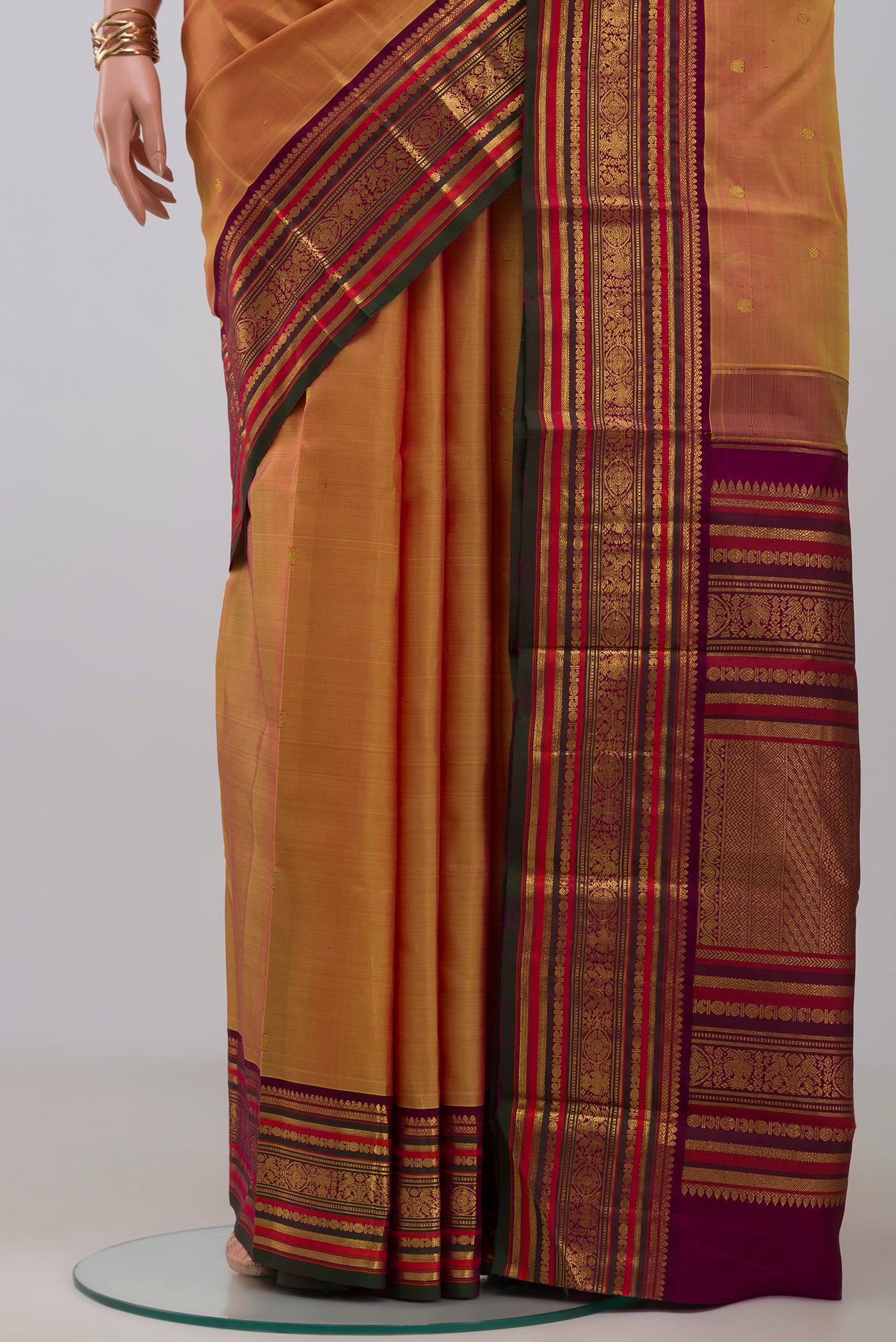 Pleats and pallu of Mustard Kanjivaram Silk Saree with Zari Butta on the body and Zari Border. 
