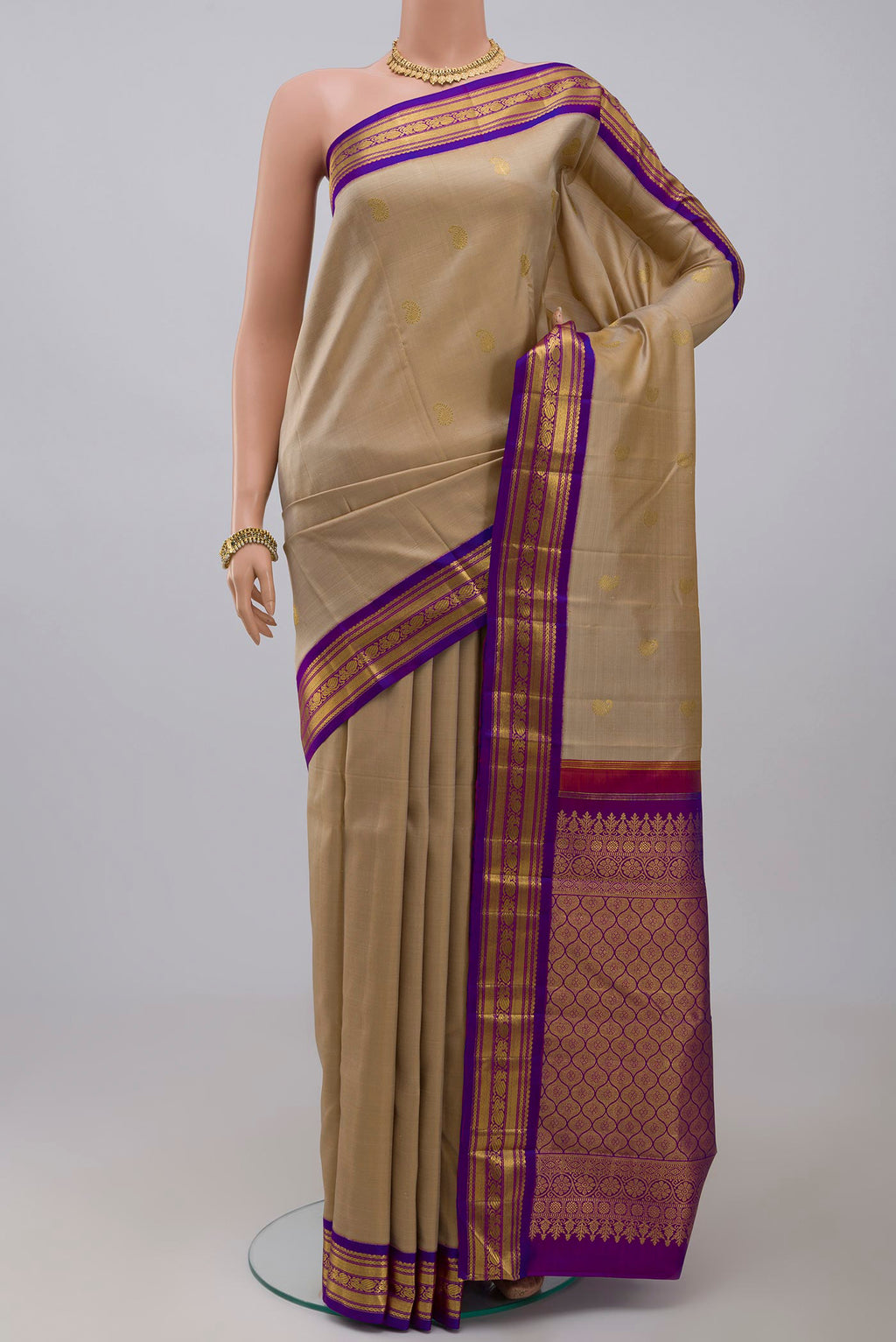 Pure Silk Pure Zari Cream Kanchipuram Saree with Zari Butta on the body and Zari Border.  displayed on a mannequin