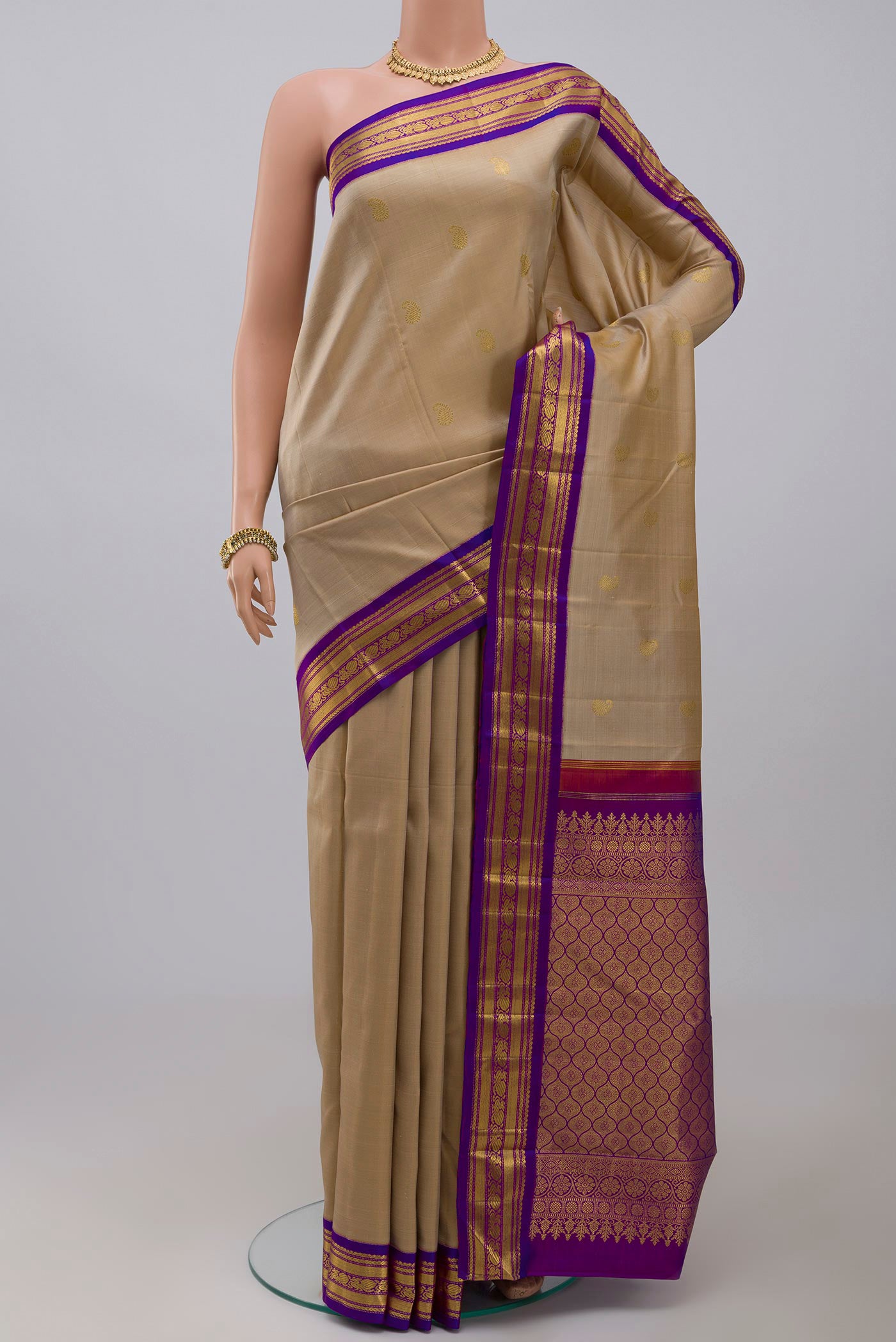 Pure Silk Pure Zari Cream Kanchipuram Saree with Zari Butta on the body and Zari Border.  displayed on a mannequin