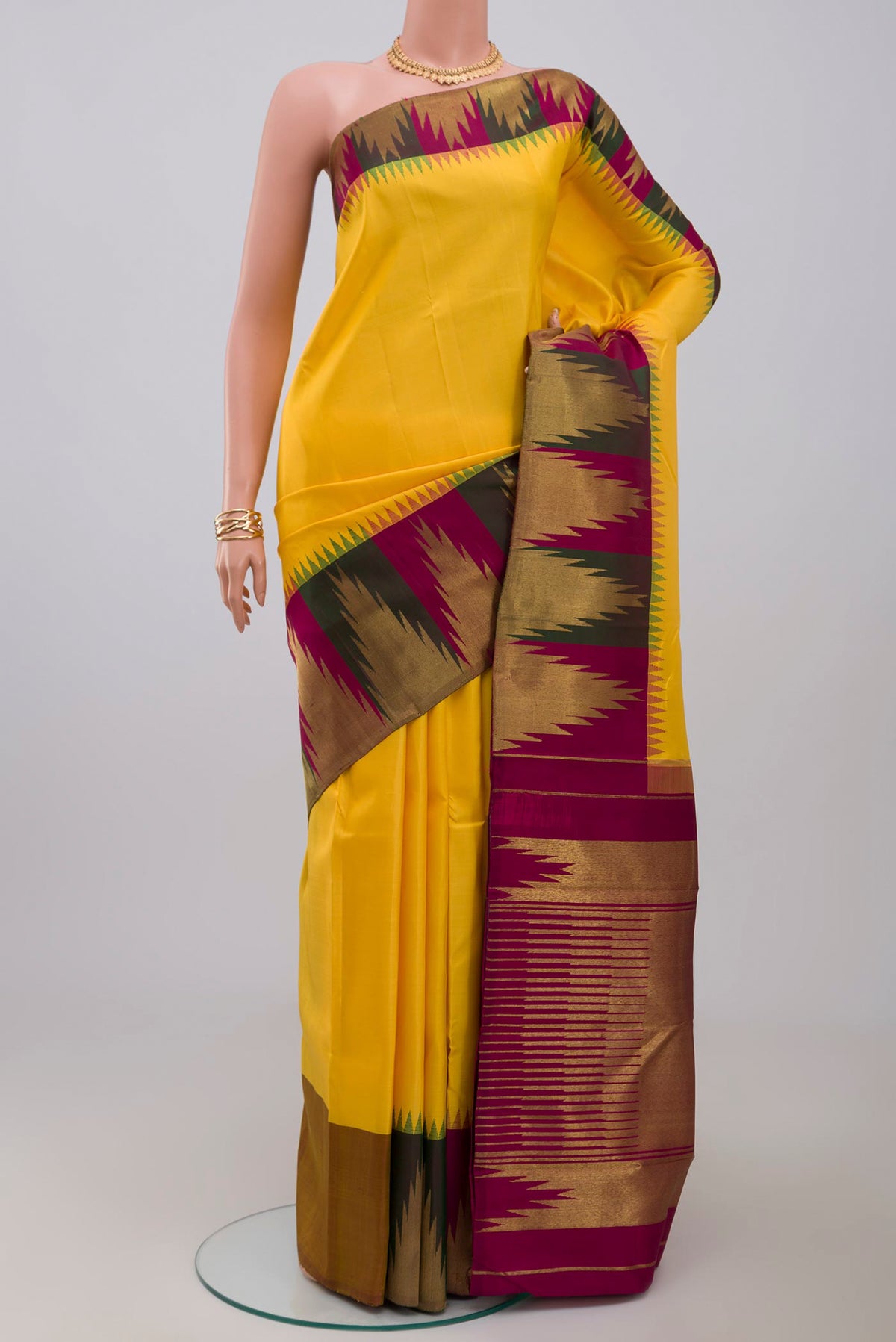 Pure Silk Pure Zari Yellow Kanjivaram Saree with Plain Body and Temple Border.  displayed on a mannequin