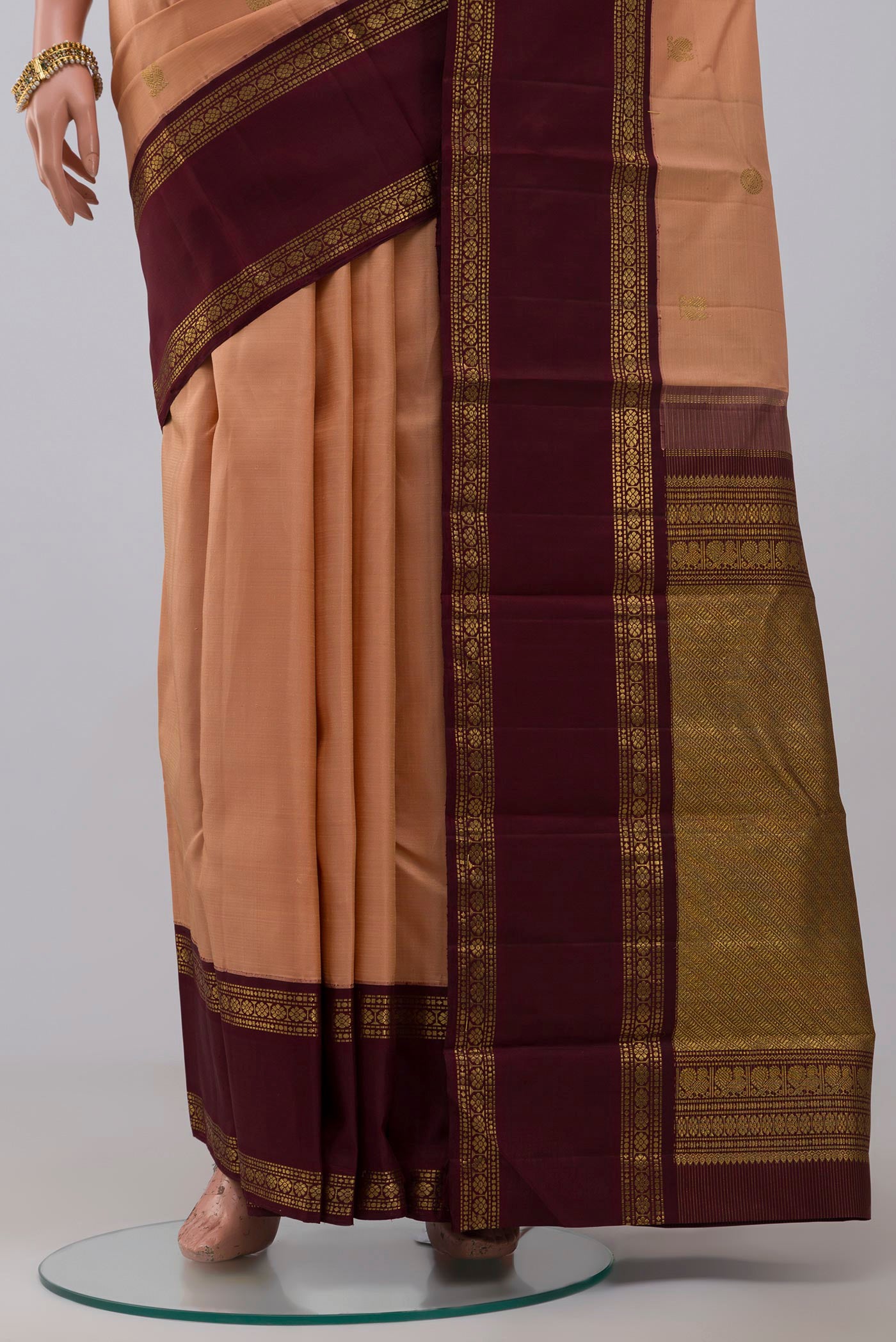 Pleats and pallu of Pure Silk Pure Zari Peach Kanchipuram Saree with Zari Butta on the body and Zari Border. 