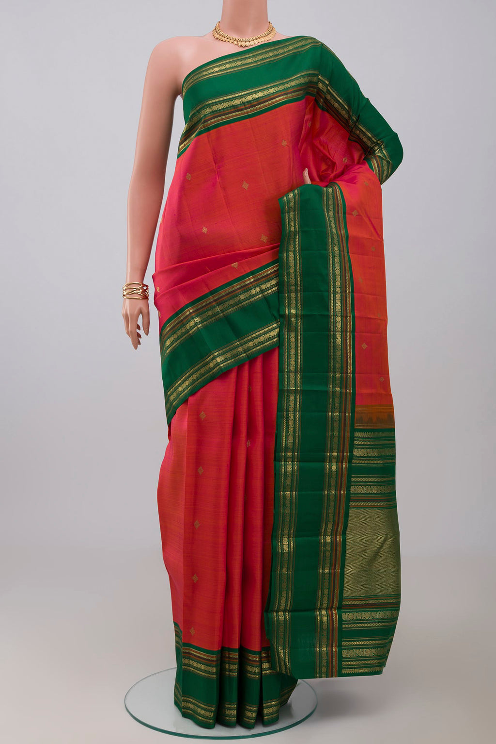 Pure Silk Pure Zari Orange Kanchipuram Saree with Zari Butta on the body and Zari Border.  displayed on a mannequin