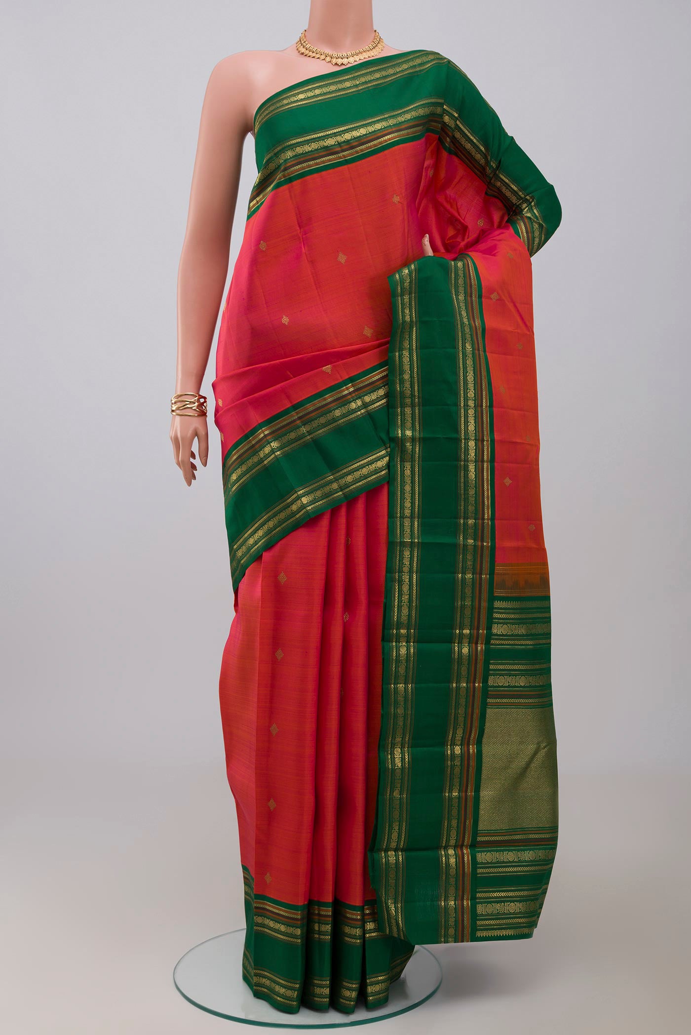 Pure Silk Pure Zari Orange Kanchipuram Saree with Zari Butta on the body and Zari Border.  displayed on a mannequin