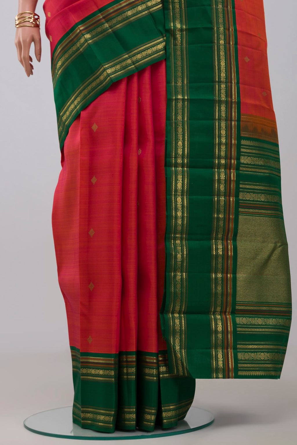 Pleats and pallu of Pure Silk Pure Zari Orange Kanchipuram Saree with Zari Butta on the body and Zari Border. 