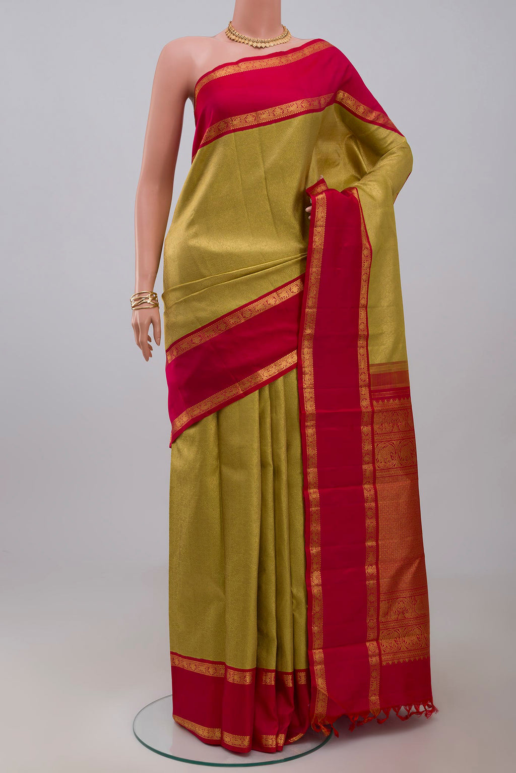 Golden Kanchipuram Saree with Zari Brocade on the body and Zari Border.  displayed on a mannequin