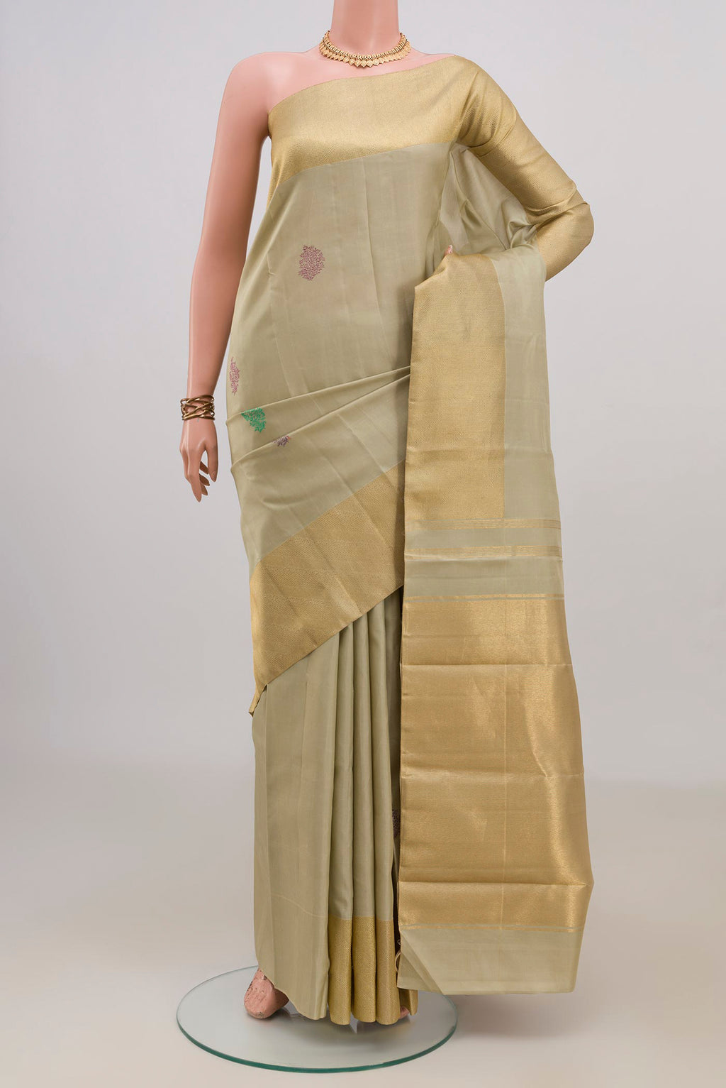 Pure Silk Beige Kanchipuram Saree with Thread Butta on the body and Zari Border.  displayed on a mannequin
