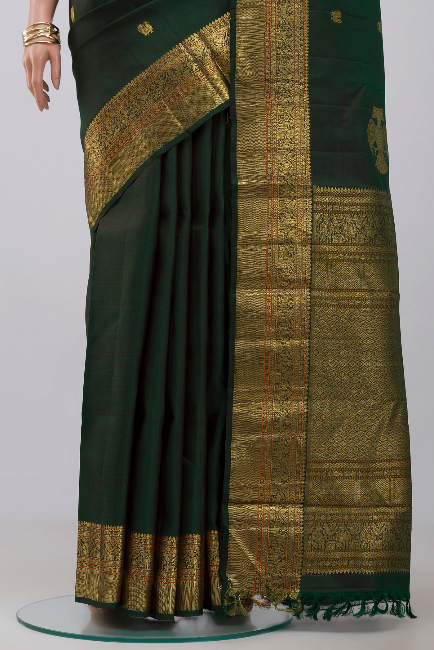 Pleats and pallu of Pure Silk Pure Zari Green Kanjivaram Saree with Zari Butta on the body and Zari Border. 