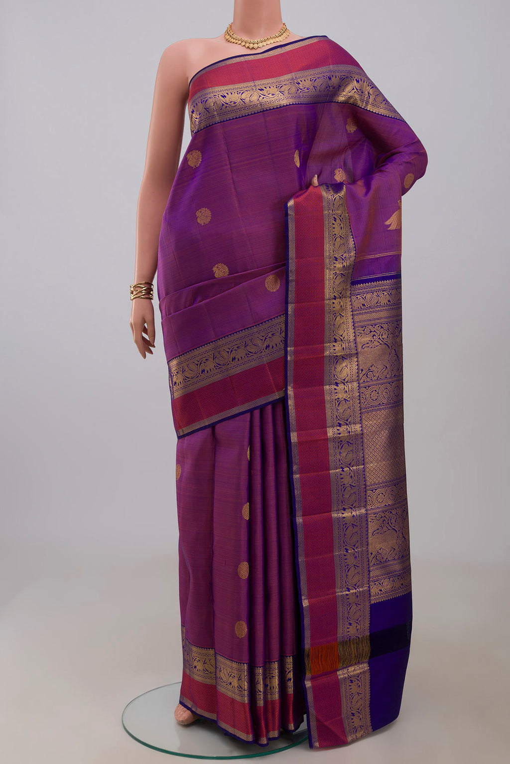 Pure Silk Pure Zari Purple Kanjivaram Saree with Zari Butta on the body and Zari Border.  displayed on a mannequin
