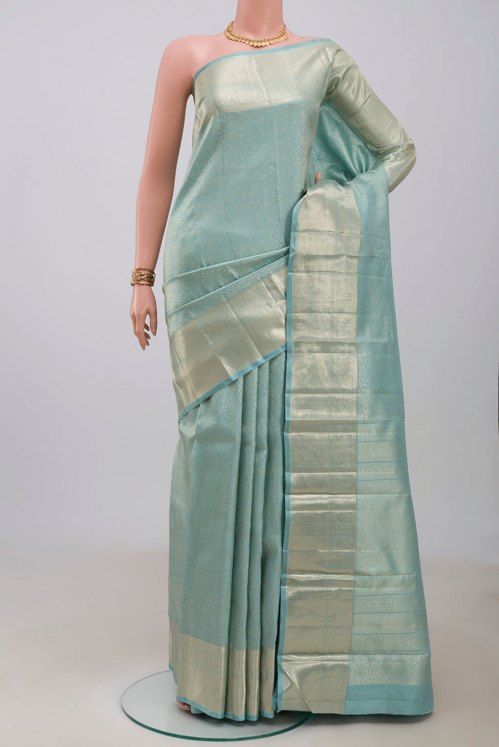 Light Blue Kanchipuram Silk Saree with Zari Brocade on the body and Zari Border.  displayed on a mannequin