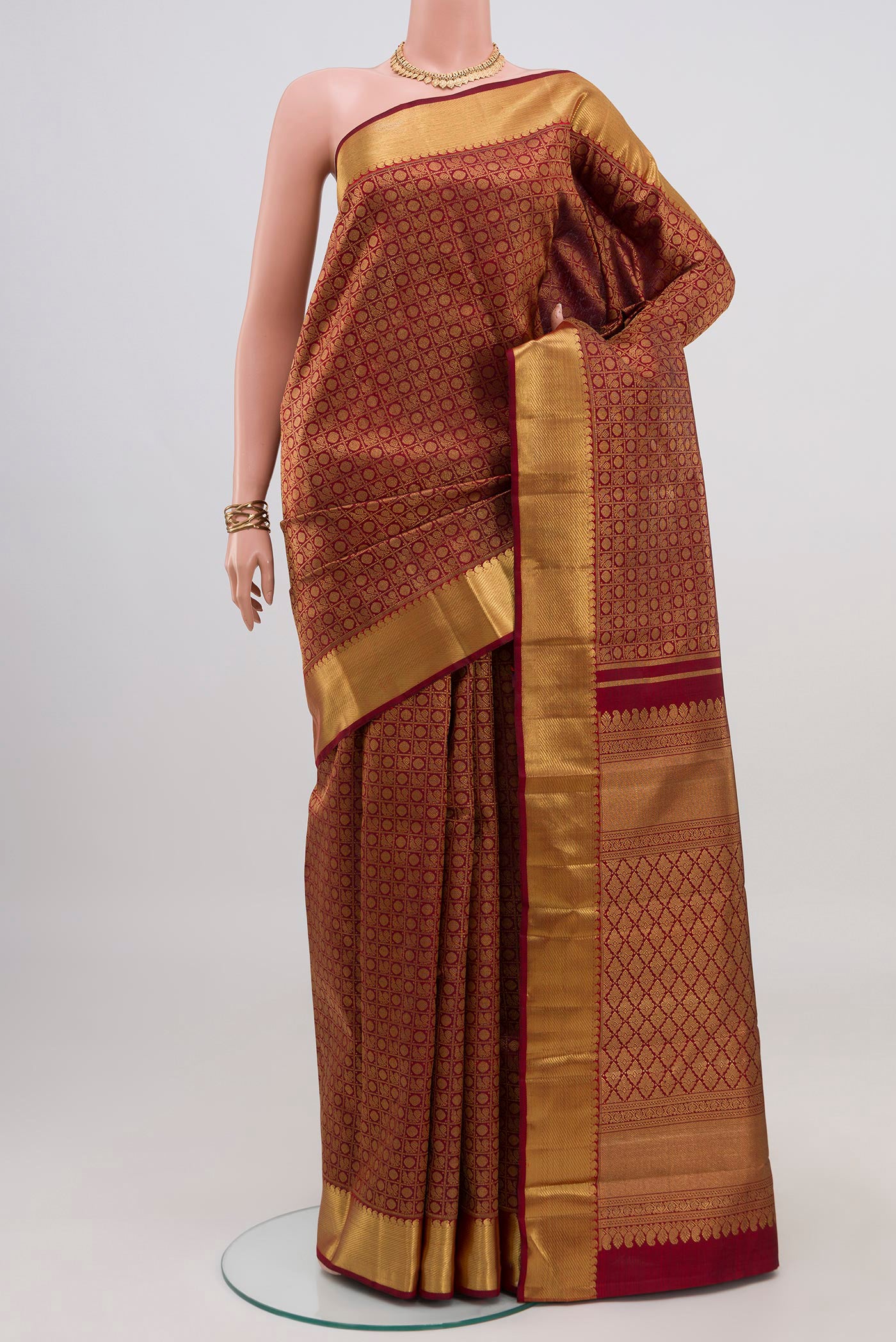 Pure Silk Pure Zari Maroon Kanjivaram Saree with Zari Brocade on the body and Zari Border.  displayed on a mannequin