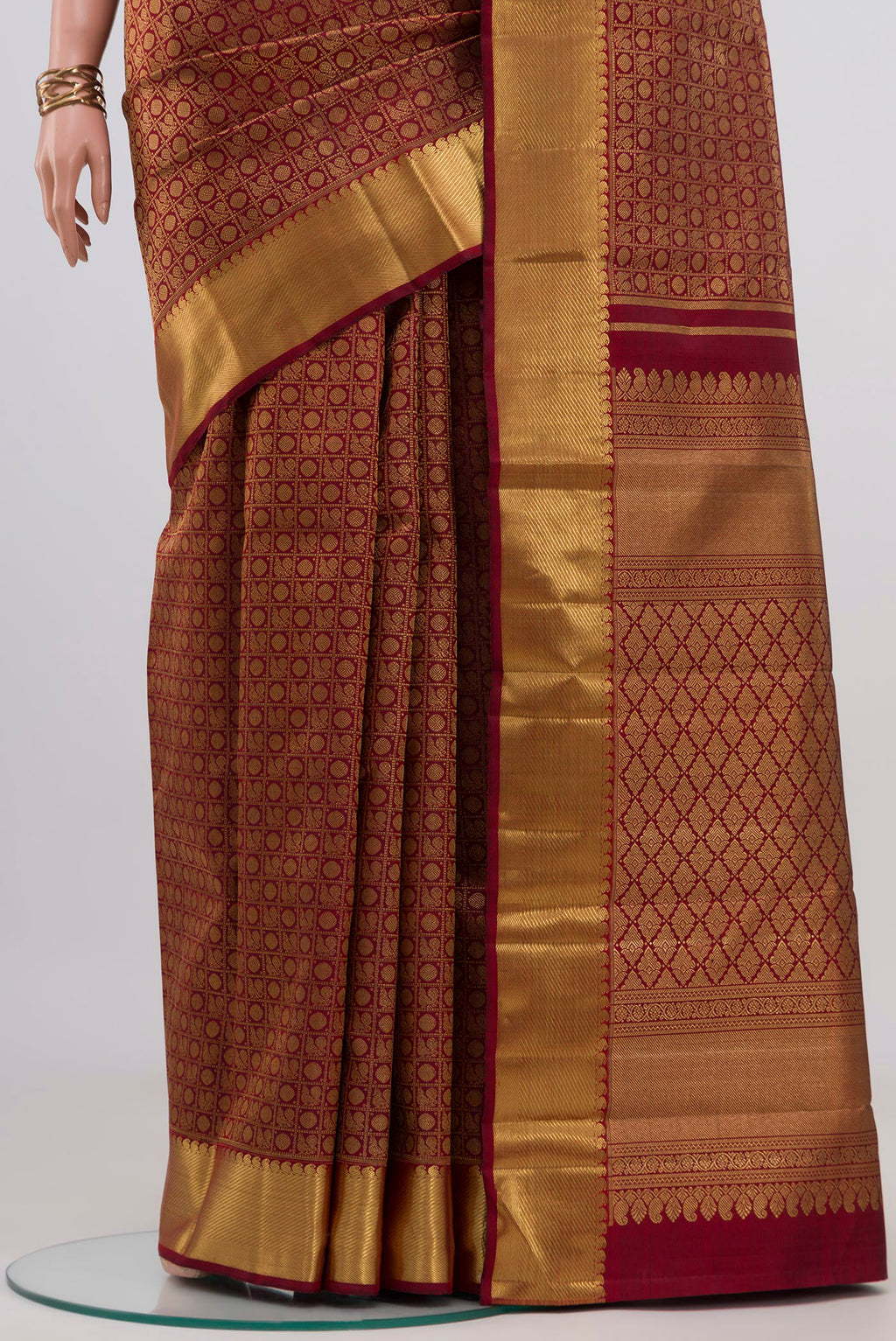 Pleats and pallu of Pure Silk Pure Zari Maroon Kanjivaram Saree with Zari Brocade on the body and Zari Border. 