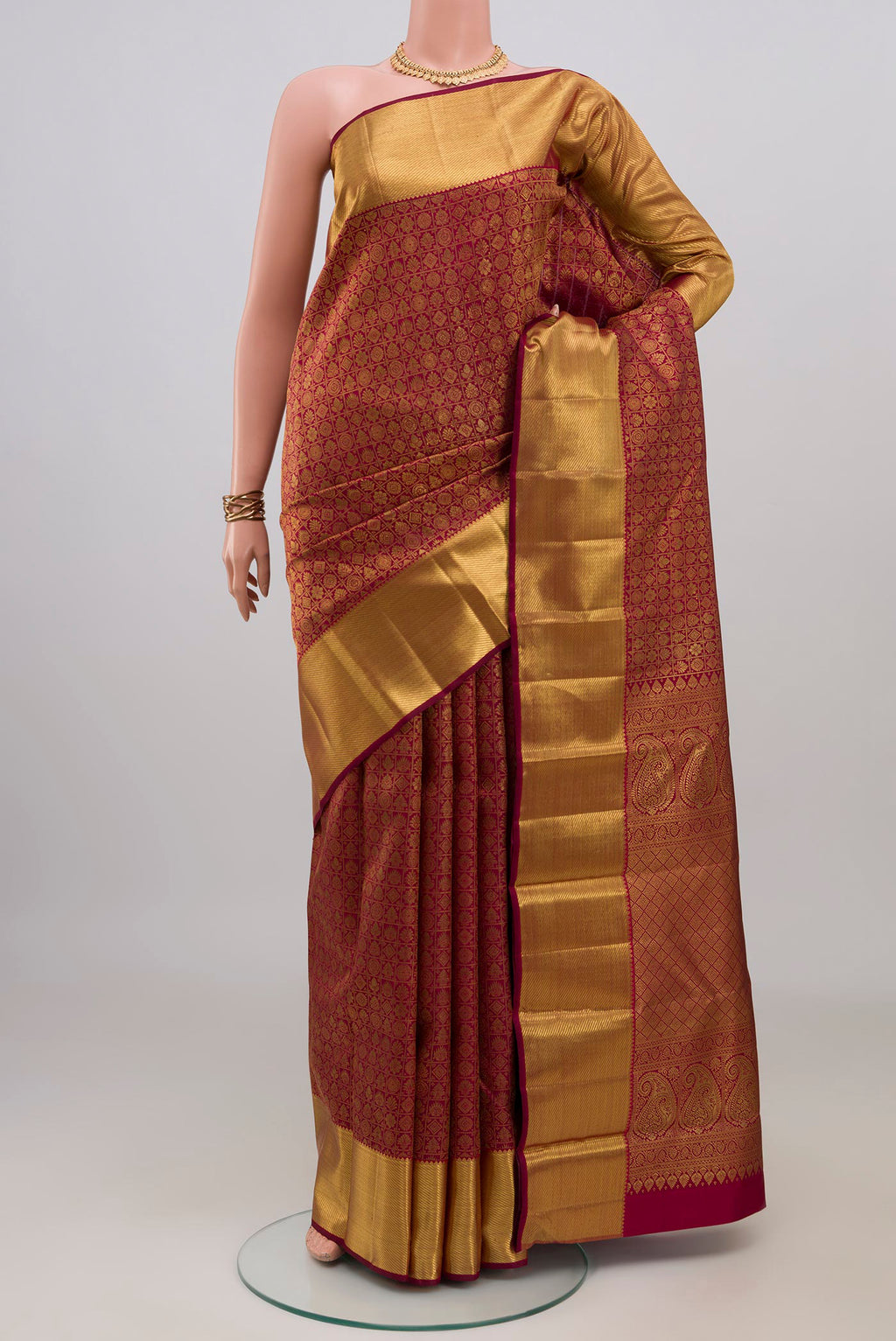 Maroon Kanchipuram Silk Saree with Zari Brocade on the body and Zari Border.  displayed on a mannequin