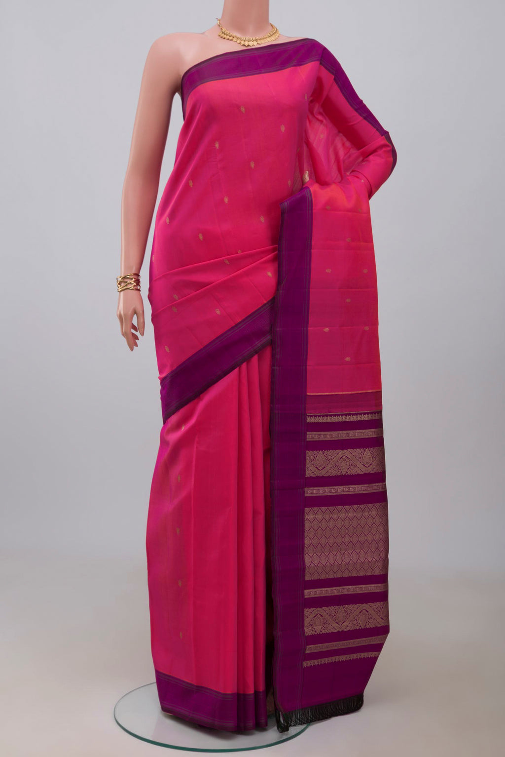 Pink Kanchipuram Silk Saree with Zari Butta on the body and Plain Border.  displayed on a mannequin