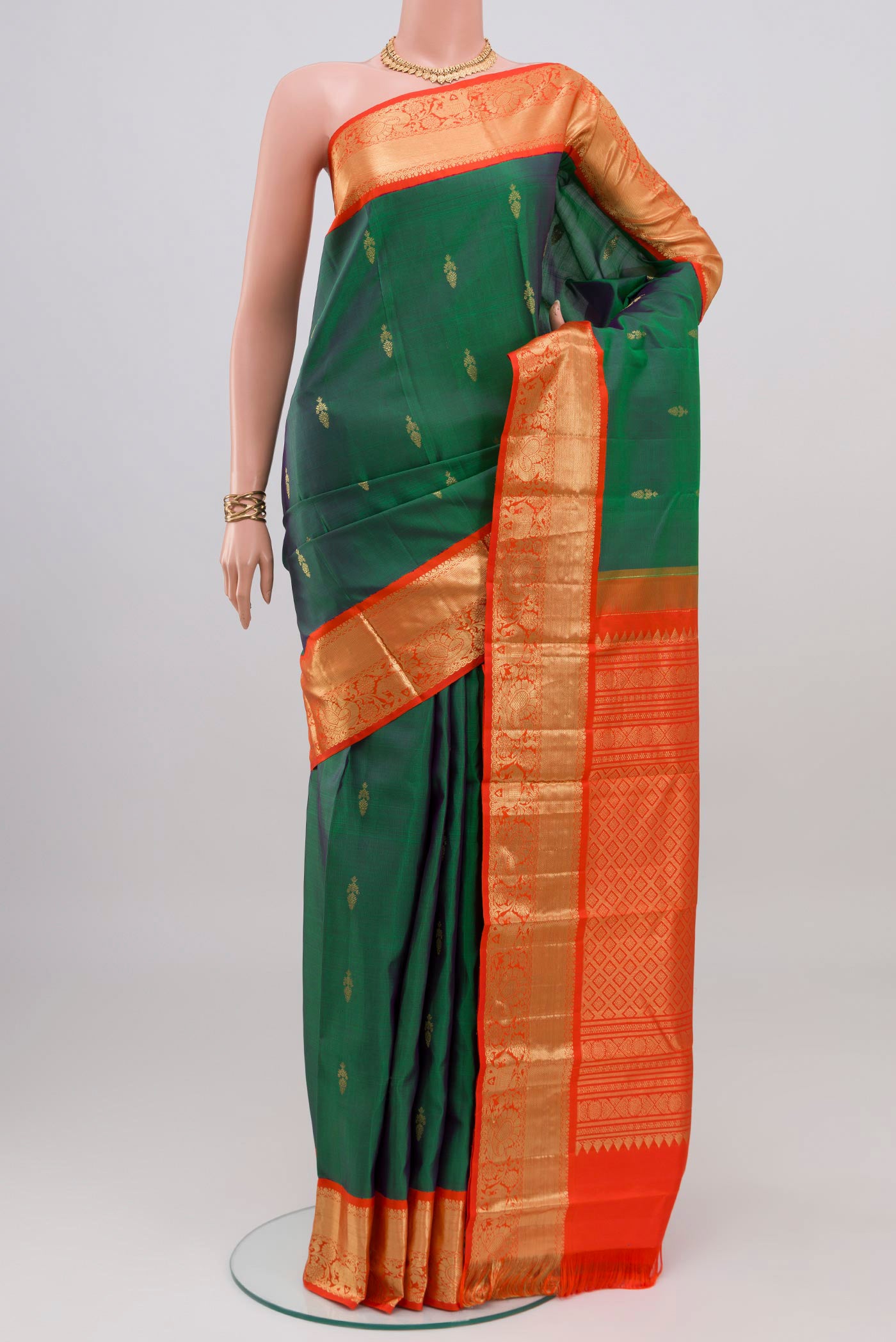 Peacock Blue Dual Tone Kanjivaram Silk Saree with Zari Butta on the body and Zari Border.  displayed on a mannequin
