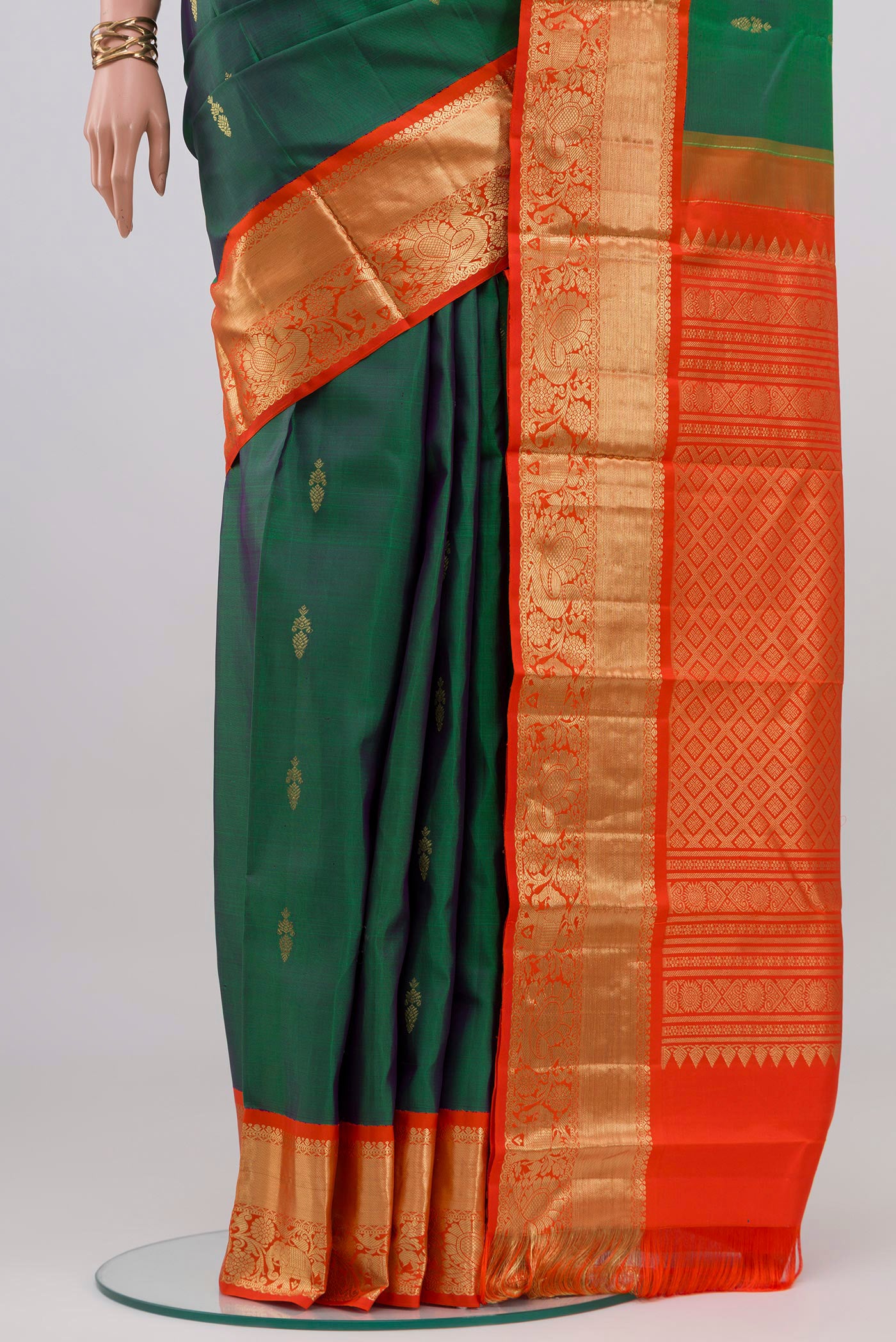 Pleats and pallu of Peacock Blue Dual Tone Kanjivaram Silk Saree with Zari Butta on the body and Zari Border. 