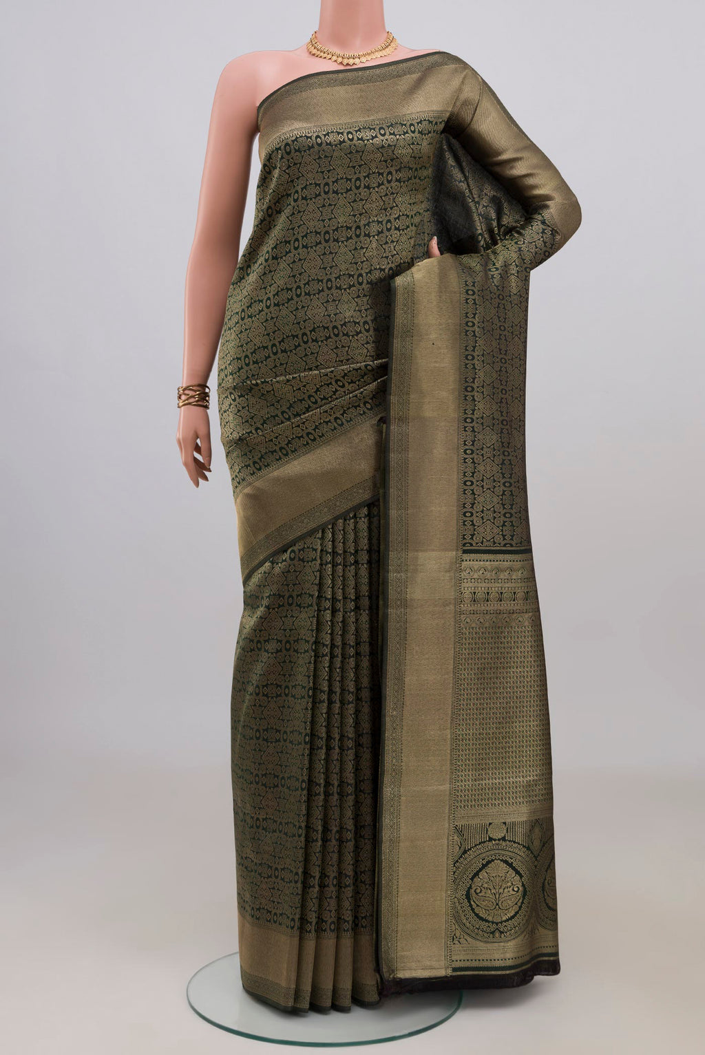 Pure Silk Bottle Green Kanjivaram Saree with Zari Brocade on the body and Zari Border.  displayed on a mannequin