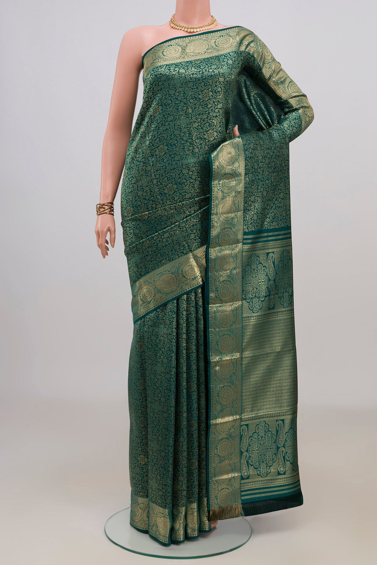 Pure Silk Green Kanjivaram Saree with Zari Brocade on the body and Zari Border.  displayed on a mannequin