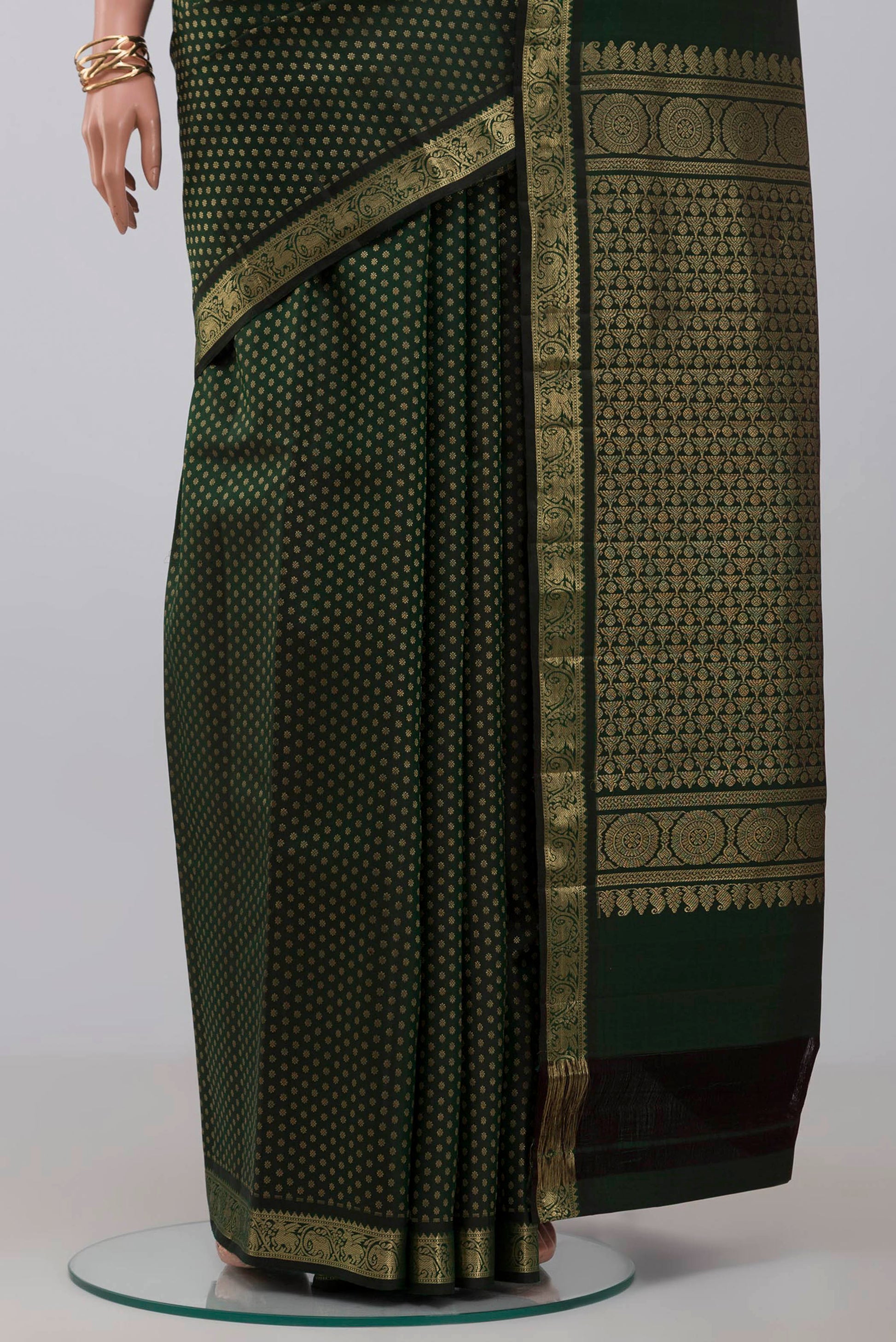 Pleats and pallu of Acid Green Kanjivaram Saree with Zari Butta on the body and Zari Border. 