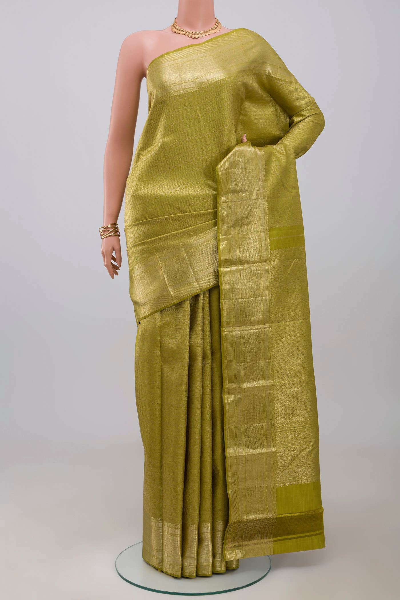 Green Kanchipuram Saree with Zari Brocade on the body and Zari Border.  displayed on a mannequin