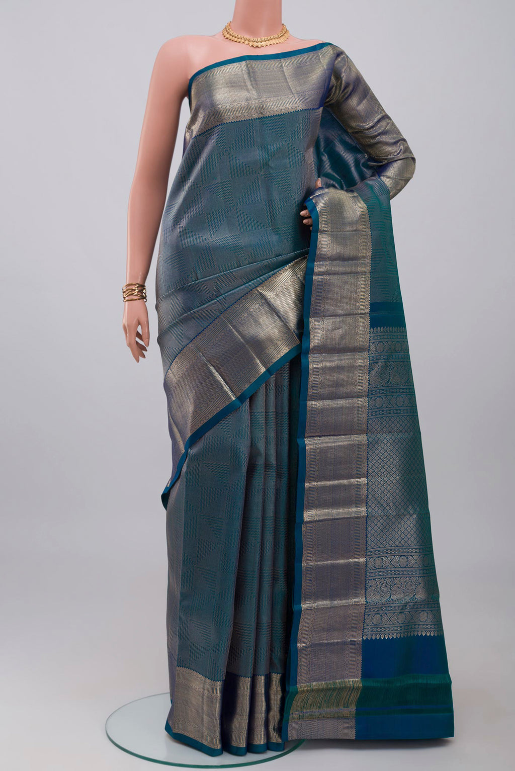 Blue Kanchipuram Silk Saree with Zari Brocade on the body and Zari Border.  displayed on a mannequin