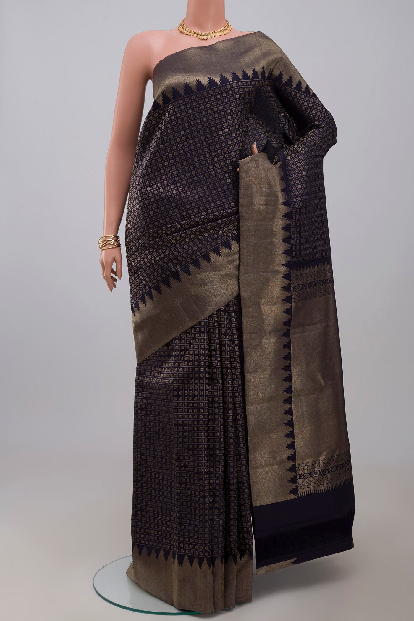 Blue Kanchipuram Silk Saree with Checked design on the body and Temple Border.  displayed on a mannequin