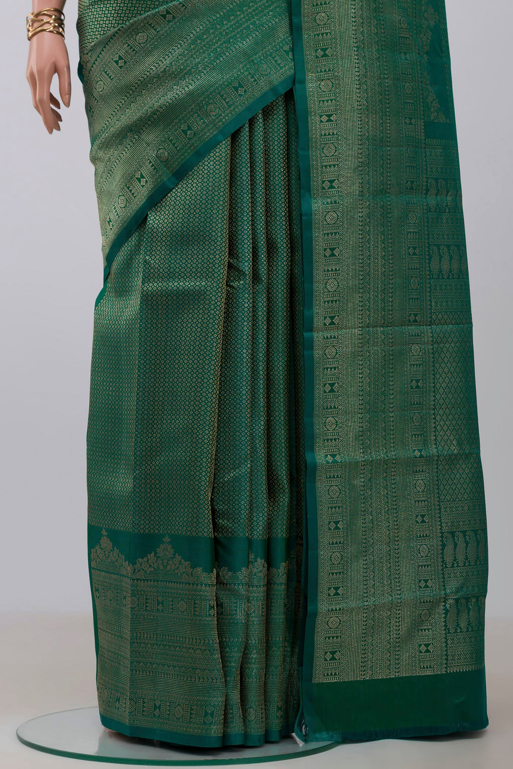 Pleats and pallu of Green Kanchipuram Silk Saree with Zari Brocade on the body and Fancy Border. 