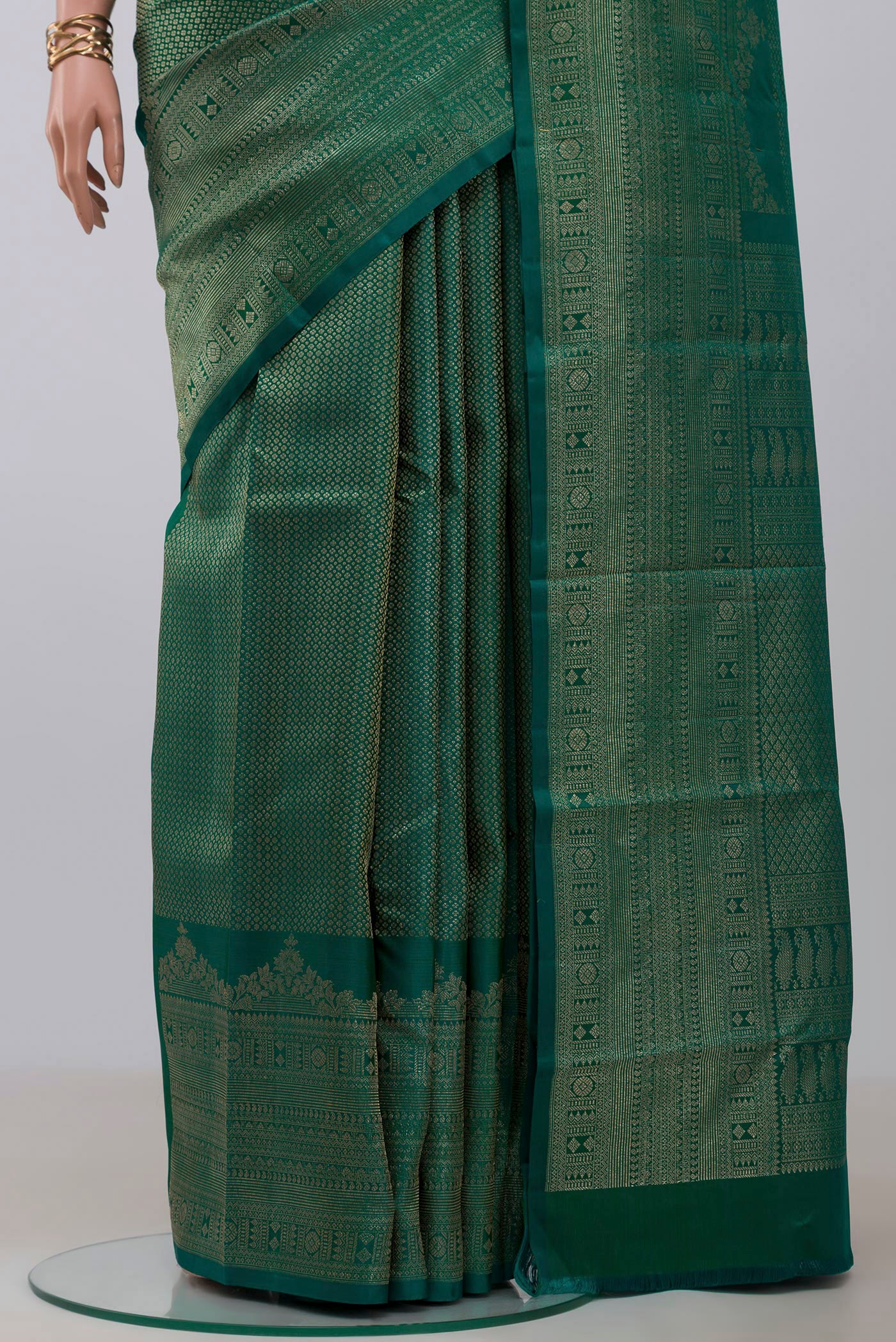 Pleats and pallu of Green Kanchipuram Silk Saree with Zari Brocade on the body and Fancy Border. 