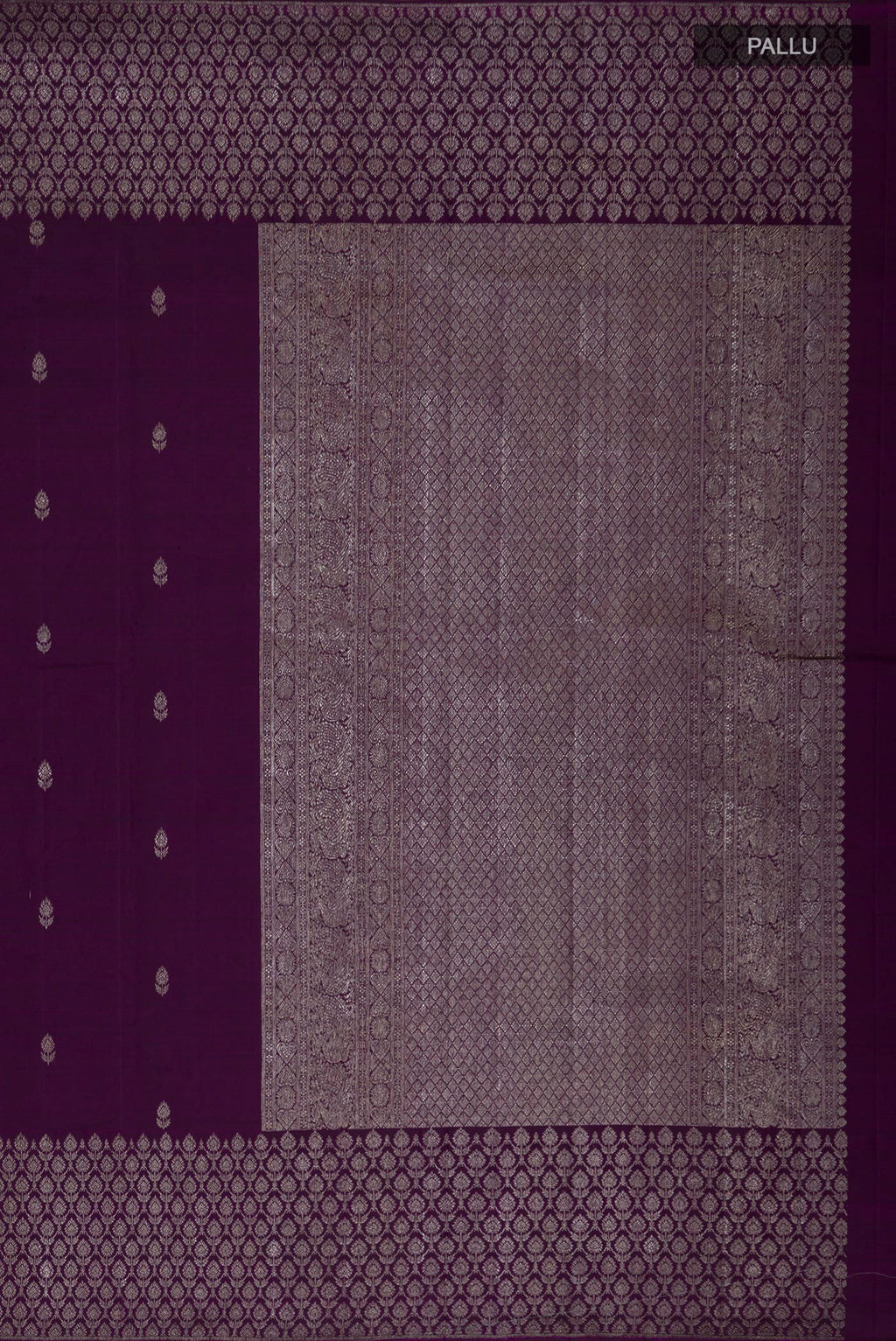 Close up image of the pallu of Purple Kanjivaram Silk Saree with Zari Butta on the body and Zari Border. 